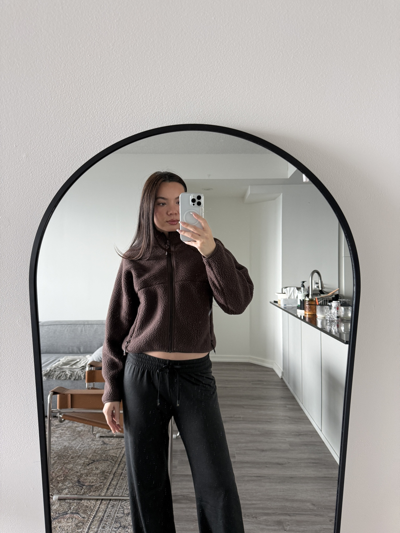 The Aritzia Polartec® Hip-Length Fleece in this deep chocolate tone paired with the Softbound Pants is the perfect balance of warmth and minimalism. The fleece has that plush, high-pile Polartec® texture — technical, durable, and incredibly soft — with a cropped, hip-skimming silhouette that keeps the look clean instead of oversized. The stand collar and smooth zipper line give it that modern, structured edge, making it feel more “elevated streetwear” than traditional fleece.

The Softbound Pants add the ideal contrast: fluid, smooth, and drapey with a relaxed straight leg that moves effortlessly. The SoftContour waistband sits flat and comfortable, giving the outfit a sleek, uninterrupted line. The combination of rich brown fleece and black pants creates that understated, neutral palette that looks intentionally styled while still being insanely comfortable.

It’s the kind of winter uniform that works for everything — coffee runs, casual days, cozy afternoons at home. Warm, soft, and quietly refined in that signature Aritzia way.

Hashtags
#Aritzia #PolartecFleece #SoftboundPants #AritziaStyle #MinimalOutfit #CozyEssentials #NeutralWardrobe #WinterLoungewear #QuietLuxuryCasual #OOTDInspo #CanadianFashion #AritziaFinds

#LTKHoliday #LTKGiftGuide #LTKootd