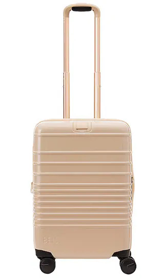 The Glossy Carry-On Roller in Beige | Revolve Clothing (Global)