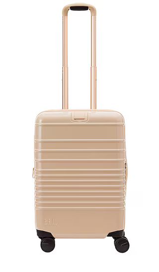 The Glossy Carry-On Roller in Beige | Revolve Clothing (Global)