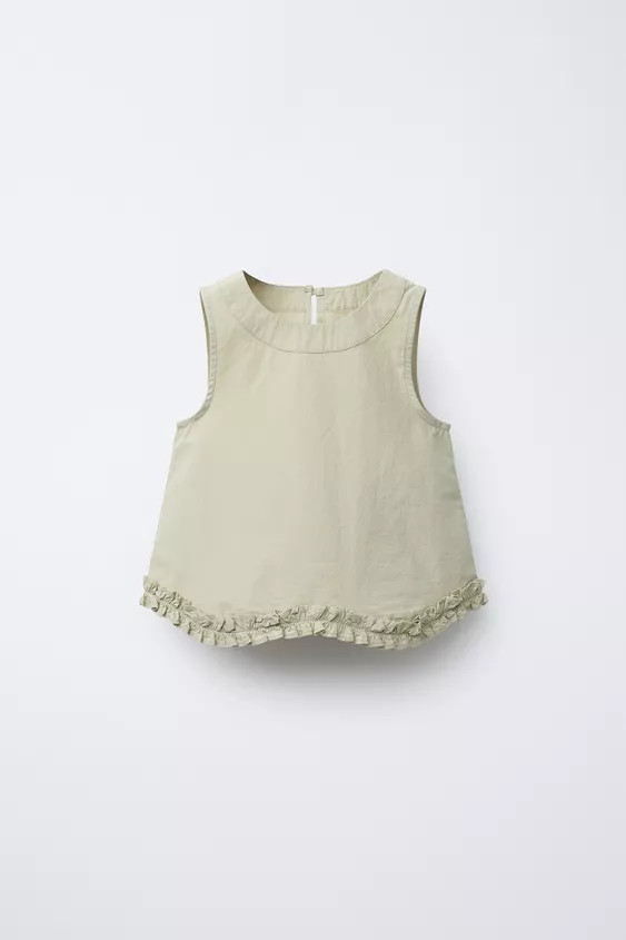 Sleeveless round neck top. Back button teardrop closure. Ruffled hem. | Zara US