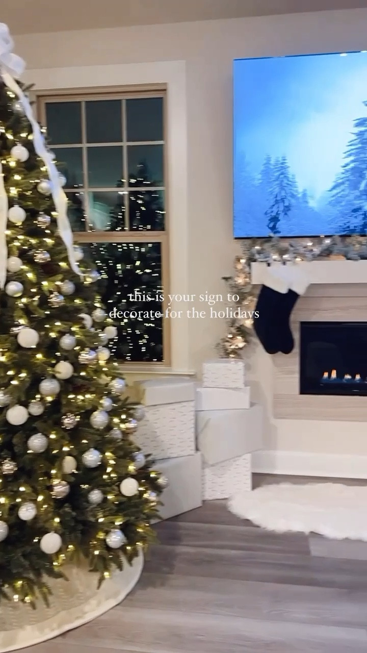 Christmas tree decorations + holiday decor that will cozy up your space this holiday season🎄✨

Here, we decorated our artificial Christmas tree with white and silver ornaments for a glitz + glam holiday look. I used white and silver wrapping paper to match when placing presents under the Christmas tree. We used a white cable knit tree skirt. I made the Christmas tree topper bow from white and silver wired ribbon. 

We added more texture to cozy up our living room with a white faux fur rug infront of the fireplace. We hung flocked garland and green stockings along the mantel. We wrapped matching flocked garland around the stair railings. At the end of each banister, I added a white and silver wired ribbon bow and silver jingle bells. 

The flocked artificial mini tree and white lantern helped add classy Christmas decor to our home. We hung green and plaid blankets from our blanket ladder. We added matching green pillow covers on the throw pillows on the couch. 

#LTKHome #LTKHoliday #LTKSeasonal