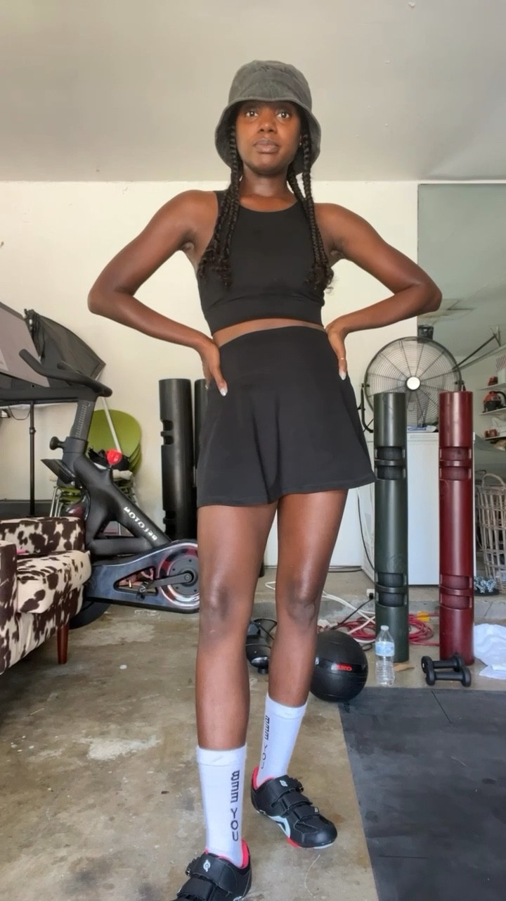 Black workout set/ travel look with sport bra and skirt (skort) Perfect for running errands and exercise. Paired with washed black bucket hat and bee you socks.   

#LTKunder100 #LTKtravel #LTKfit