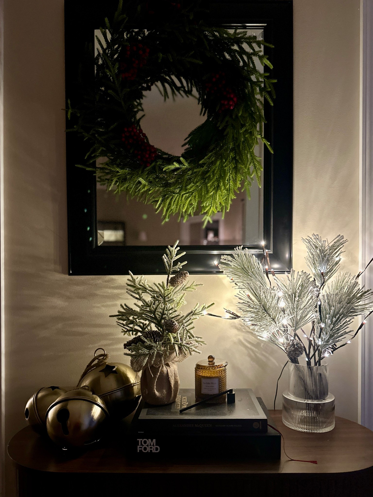 Transitioning to the new year with this simple seasonal console styling with a Norfolk pine wreath and frosted pine tree and branches with LED branches for evening glow  

#LTKSaleAlert #LTKSeasonal #LTKHome
