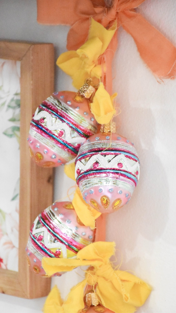 feelin’ egg-stra 🥚✨ #gifted ribbon, and bows, and @oldworldchristmas ornaments oh my! this may be my easiest DIY yet .. and I kinda love it. I had a vision and it changed a few times along the way but the outcome is fun and sparkly and giving all the spring vibes 🌸 do you have ornaments you’d do this with? 

✨ comment EGG for a link to shop these ornaments and some other spring favs 🌿 #springdiy #springdecor #easterdecor #easterdiy