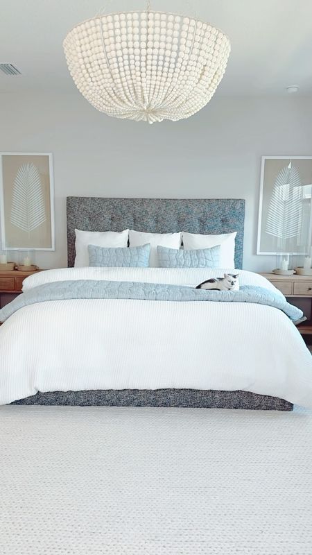SALE ALERT‼️ Most of the Pottery Barn items in our bedroom are majorly discounted! Bedding is 20% OFF this weekend only! The white Honeycomb Cotton Duvet cover and matching euro shams are marked down on clearance! The chambray Cloud quilt and matching shams are on sale! Even the long palm leaf shadow box art is at a discounted price! The ivory chunky knit sweater handwoven rug is on sale for a limited time! The artisan handcrafted ceramic hurricane candleholders are 20% off too!

Our Sausalito nightstands are in a seafrift finish which gives the bedroom a modern coastal look. They are very solid and provide wide drawers for storage. The wood bead chandelier adds character and charm while also functionally providing more light to brighten the room. The chunky knit sweater handwoven rug makes the room feel cozy all year long! It comes in a variety of sizes. We went with the 9’x12’ to go with our king bed. In order to make the bedding look extra cozy and cloud-like, we added an extra Buffy comforter inside the duvet. The white Honeycomb Cotton Duvet is the perfect material and neutral in color, so it can be used all year long. The chambray cloud quilt and matching pillow shams give the room a touch of color to make it interesting. The artisan handcrafted ceramic hurricane candleholders in white gray compliment the nightstands!

Neutral Bedroom, Modern Coastal Bedroom, Beach House, Bedding Sale, Pottery Barn, White Duvet, Waffle Knit, Honeycomb Bedding, Neutral Bedding, White Bedding, White Comforter, Light Blue Bedding, Blue Quilt, Coastal Bedroom, Master Bedroom, Palm Leaf, Calm Bedroom, Light Bedroom, Airy Bedroom, Bright Bedroom, Natural Bedroom, Linen, Beach House Inspiration, Bedroom Inspiration, Bedroom Sale, Nightstands, Pottery Barn, Nightstand Styling, Bedroom Styling, Guest Bedroom, Coastal Bedroom, Woven Rug, Ivory Rug, Neutral Nightstand, Natural nightstand

#LTKsalealert #LTKhome #LTKstyletip