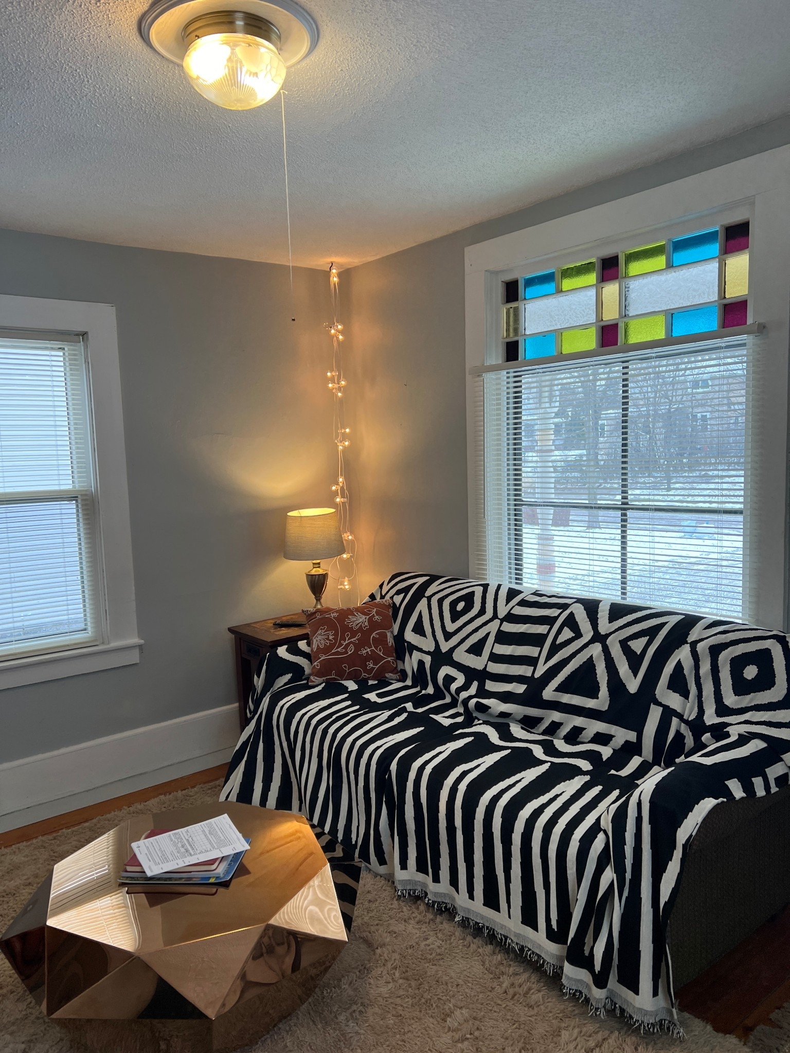 Mixing graphic patterns with warm lighting for a cozy living room moment. The geometric throw, sculptural coffee table, and soft rug keep this space feeling modern but relaxed. Linking similar pieces to recreate the look 🤍

#LTKHome