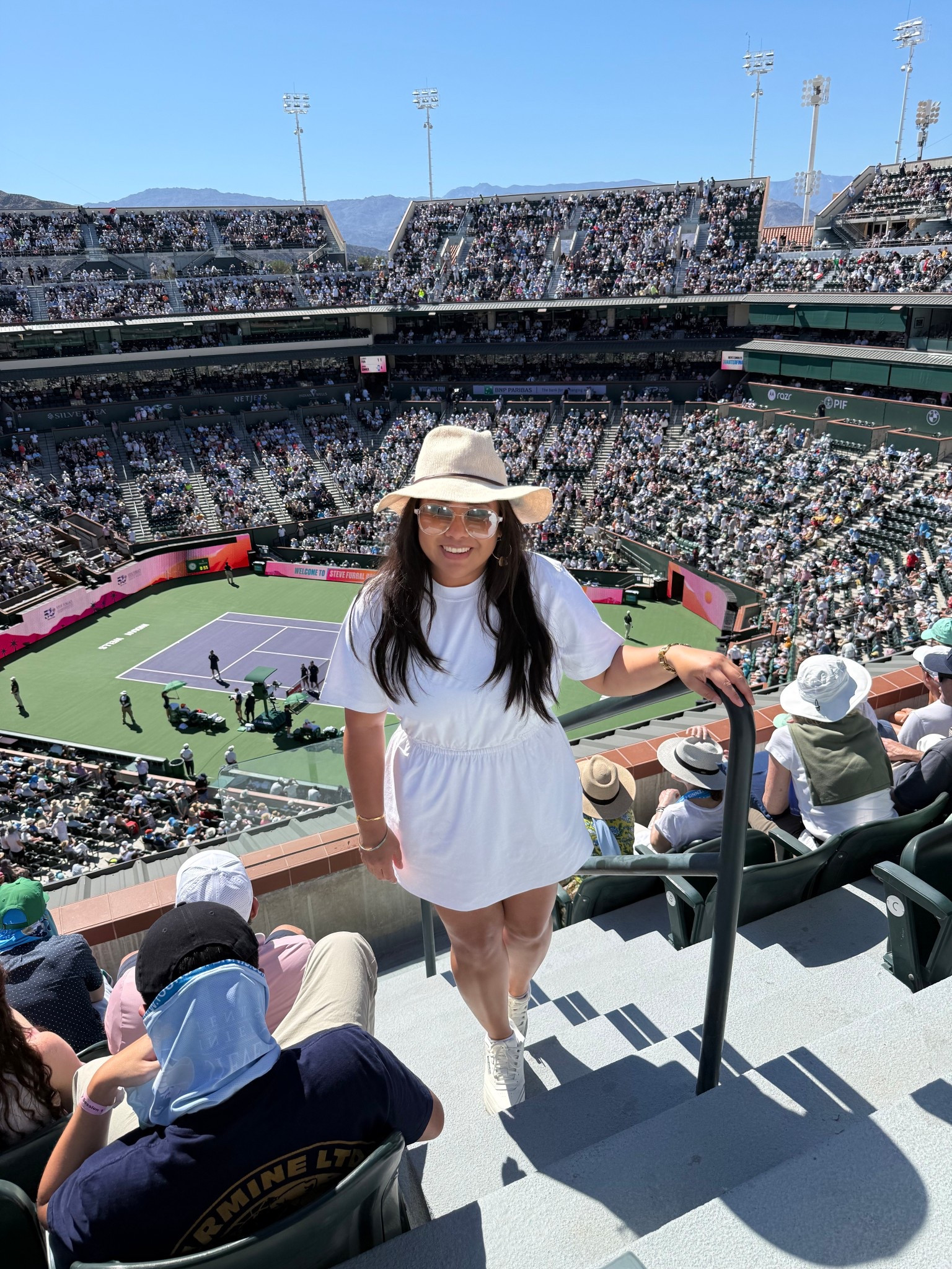BNP Paribas Indian Wells Outfit Idea

Sharing what I wore for a sunny day at the tennis in Indian Wells. I love an outfit that feels effortless but still a little elevated for a full day walking the grounds and watching matches.

My base piece was a white tee dress from lululemon. It is one of those easy staples that always works because the waist is slightly cinched so it still feels flattering and feminine while staying comfortable for a full day out.

To elevate the look a bit I added a tan hat which gave the outfit a polished, sun ready feel. Platform reebok sneakers added some height while still being practical for all the walking around the tournament.

Accessories made the outfit feel playful and girly. I wore citrine drop hoop earrings which add the prettiest warm glow against neutral tones, along with clear frame aviator sunglasses that felt fresh and sporty for a bright desert day.

Easy, sporty, and a little elevated for a day at the BNP Paribas Open.

#bnpparibasopen #indianwellstennis #tennisoutfit #tennisstyle #lululemonstyle #teedress #sportyoutfit #athleisurestyle #platformsneakers #springtennisstyle

bnpparibas open outfit | indian wells tennis outfit | tennis tournament outfit ideas | lululemon tee dress outfit | sporty chic outfit | tennis spectator style | athleisure outfit ideas | platform reebok sneakers outfit | clear aviator sunglasses outfit | spring tennis fashion | desert tennis style

#LTKActive #LTKootd #LTKPetite
