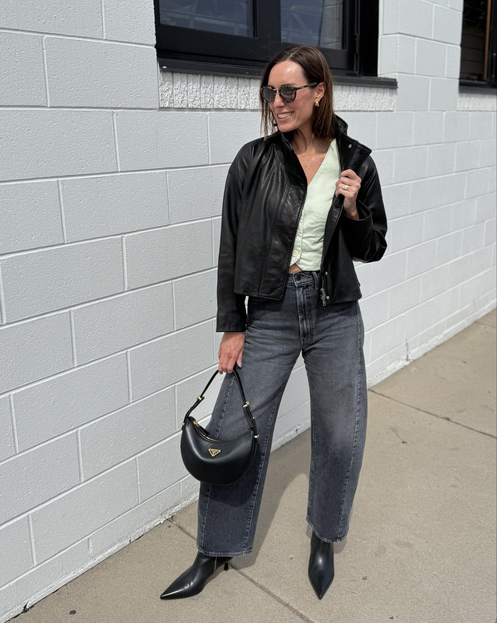 Springtime in the city! Cool weather day, so layered up a bright light vest with my crop leather jacket. Still ticking my boots with my barrel leg jeans. Sandal season soon, though!! Accessorized with my black leather Prada handbag and tortoise shell sunnies. 🕶️