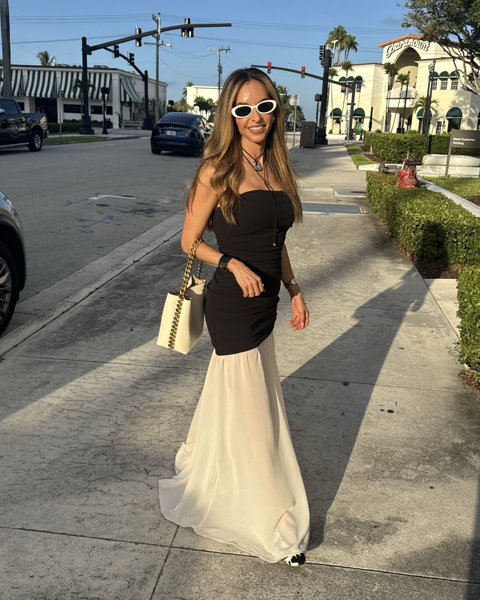 Sunset strolls in style ☀️🖤
This black strapless mini dress layered with a flowy beige chiffon overlay skirt is giving effortless elegance with a modern twist.

Styled with retro white sunglasses, a structured white shoulder bag with chain detail, and a western-inspired pendant necklace — perfect for warm Florida days or a summer vacation escape.

This look is ideal for golden hour moments, city strolls, or beachside dinners.

#LTKTravel #LTKSeasonal #LTKSummerEdit