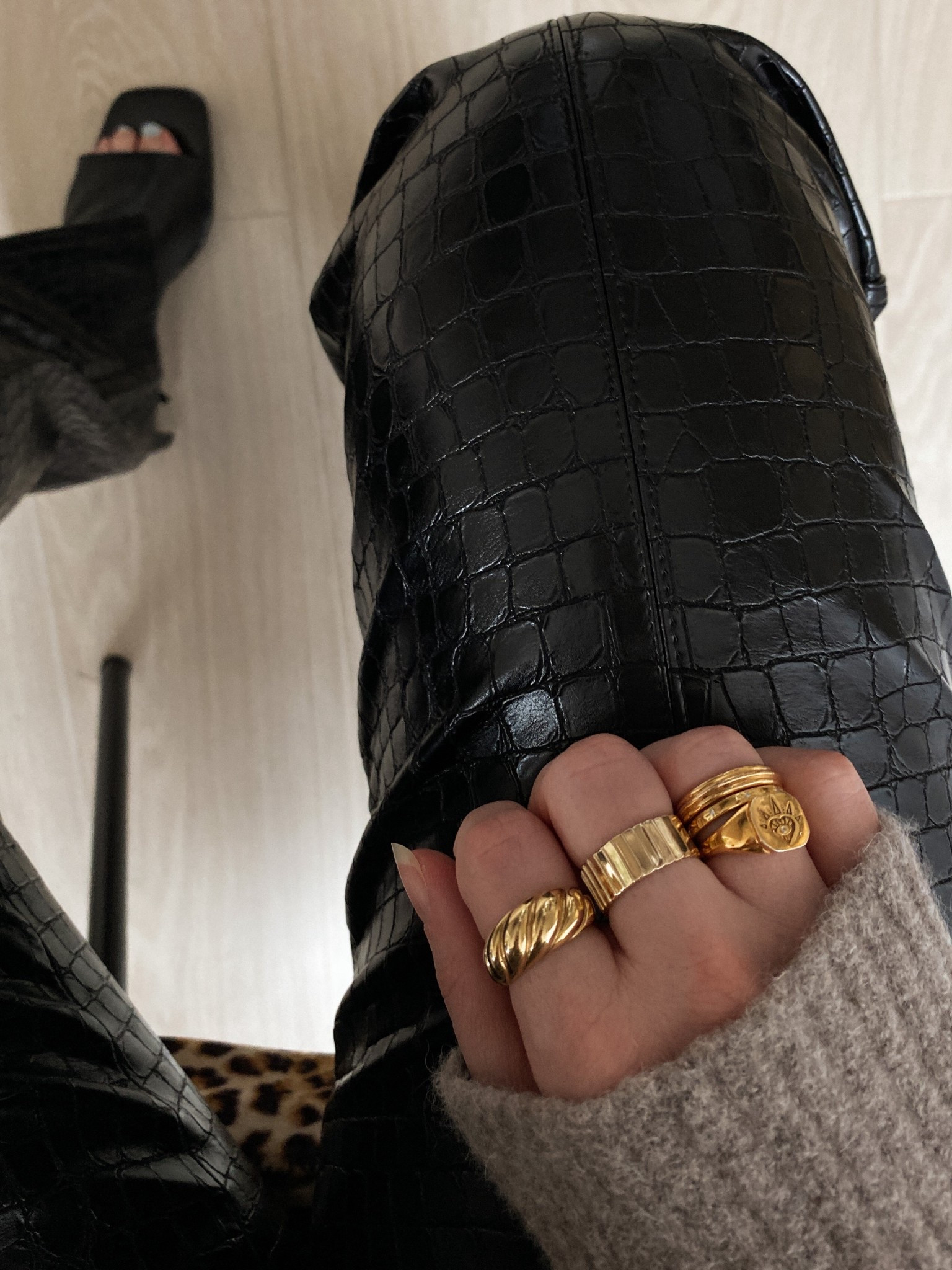 From above: black snakeskin trousers meet a golden ring stack.
Croissant, cigar, heart signet and slim bands - texture on texture. 🖤✨
.
snakeskin trousers outfit, gold ring stack, croissant ring, heart signet ring, cigar band, gold bands, statement rings, everyday jewellery, edgy chic style, jewellery layering, autumn layers, knitwear 

#LTKautumn #LTKgiftguide #LTKluxury