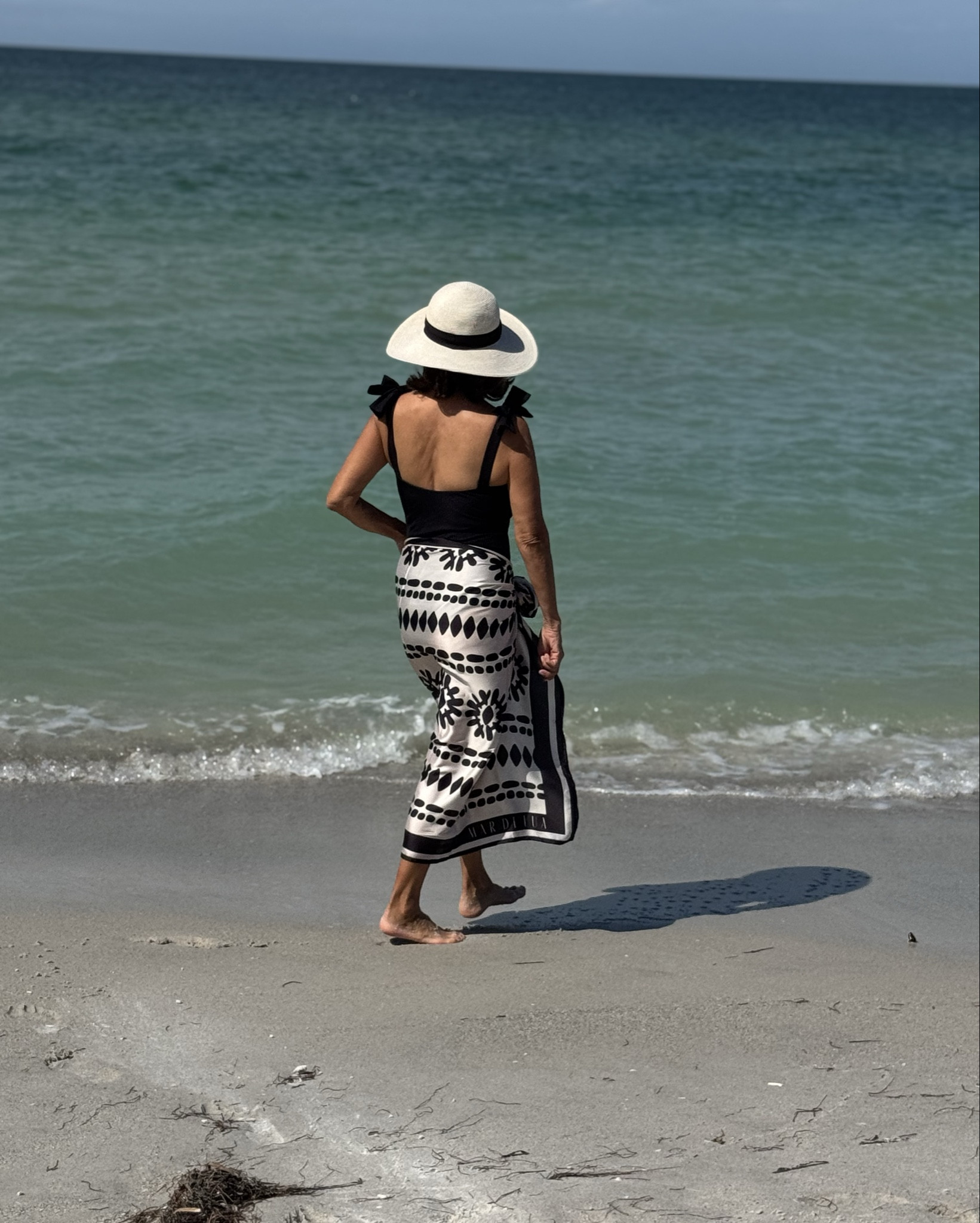 Black and white never fail. Elegant, simple, and effortlessly chic. A timeless convertible for sunny days. 
Swimsuit +pareo+ straw hat: classic perfection.  Ageless style

#LTKSwim #LTKActive #LTKPetite