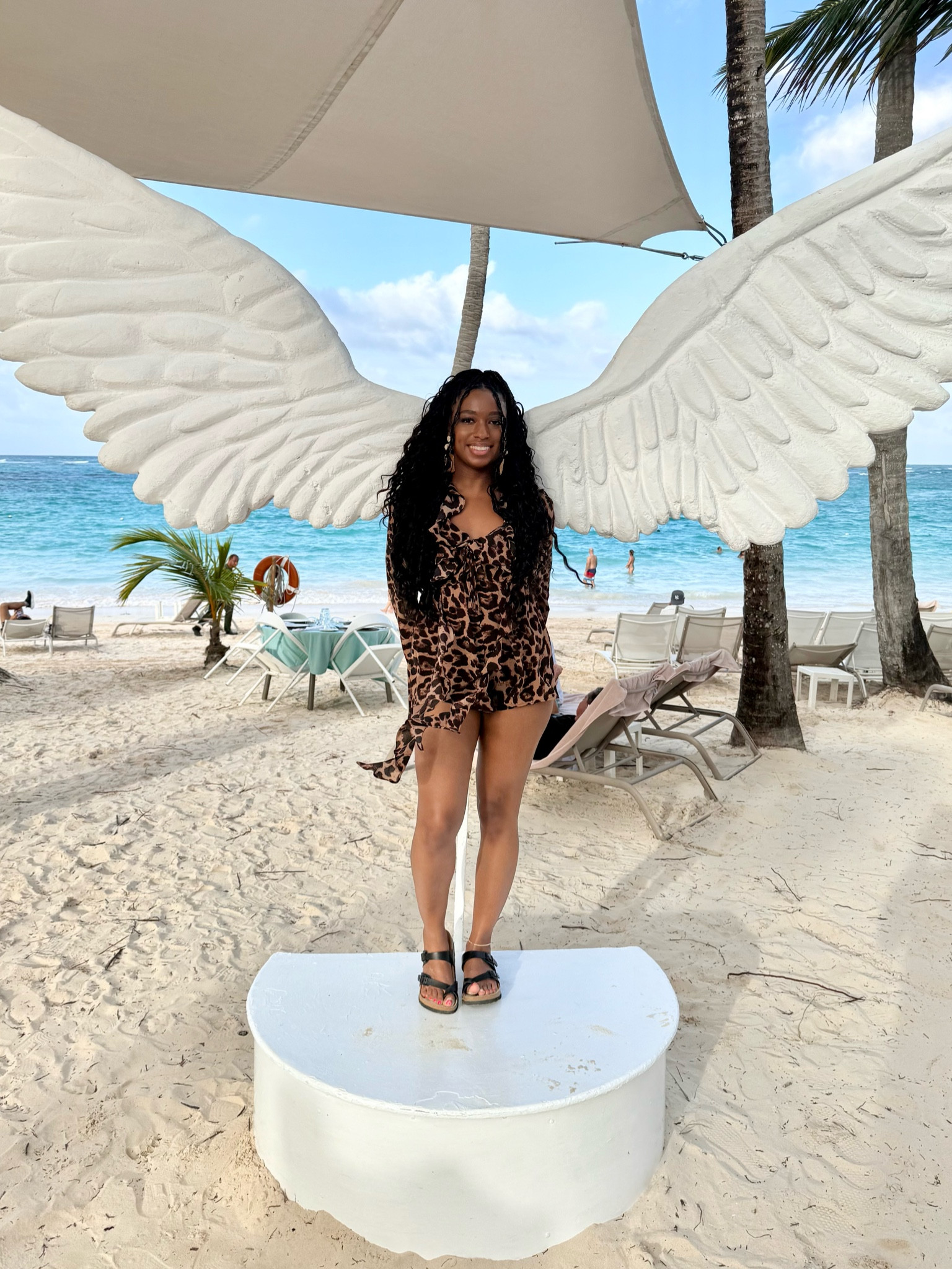 Elegant leopard print jumpsuit, really pretty loose wave braiding hair, classic black sandals & vacation earrings! #vacation 

#LTKTravel #LTKSeasonal #LTKFindsUnder50