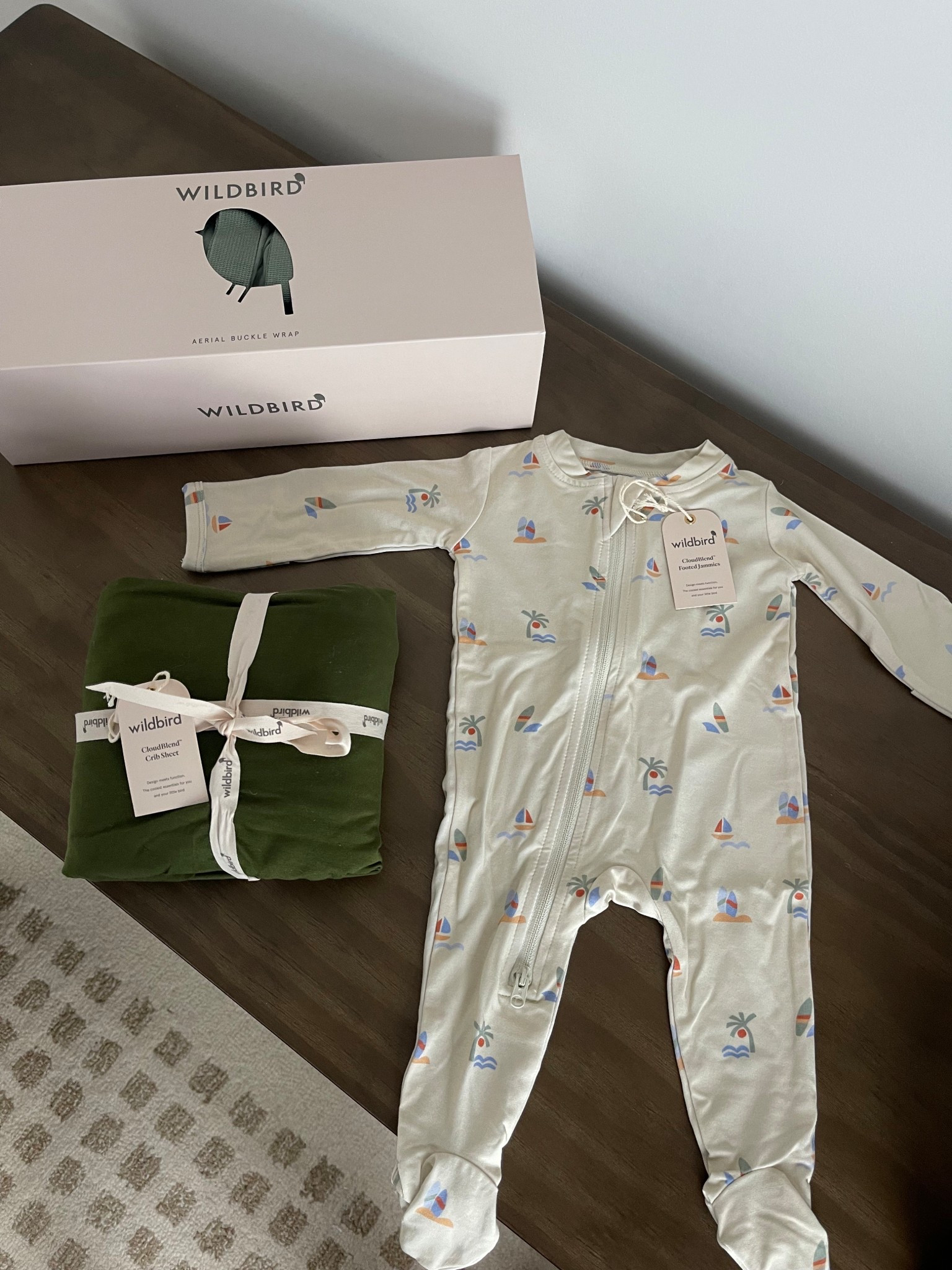 wildbird newborn essentials | footed sleepers, crib sheets, baby carrier