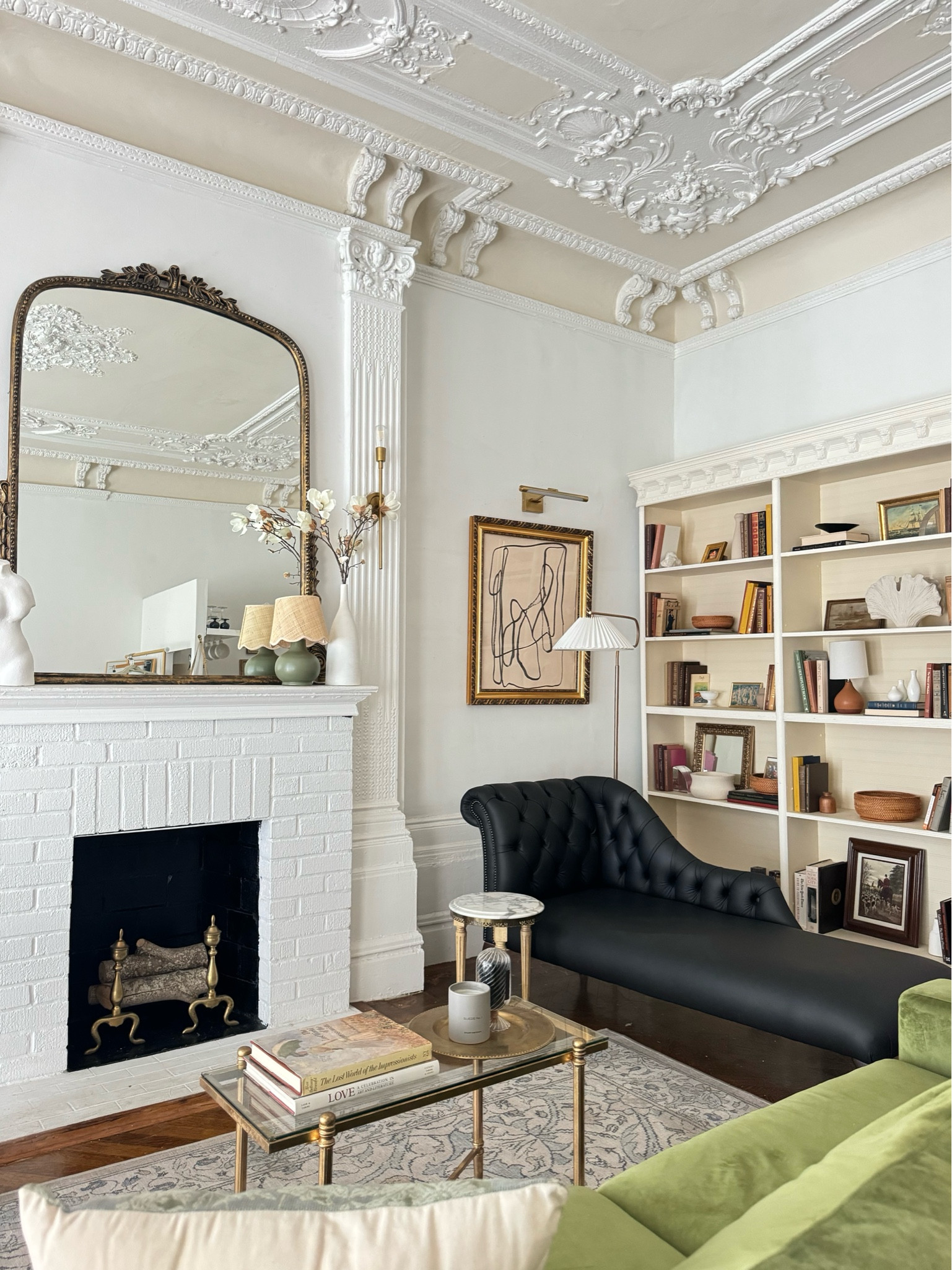 Studio details- mantle mirror, black leather chaise, pleated floor lamp, coffee table, abstract framed art 

#LTKStyleTip #LTKHome