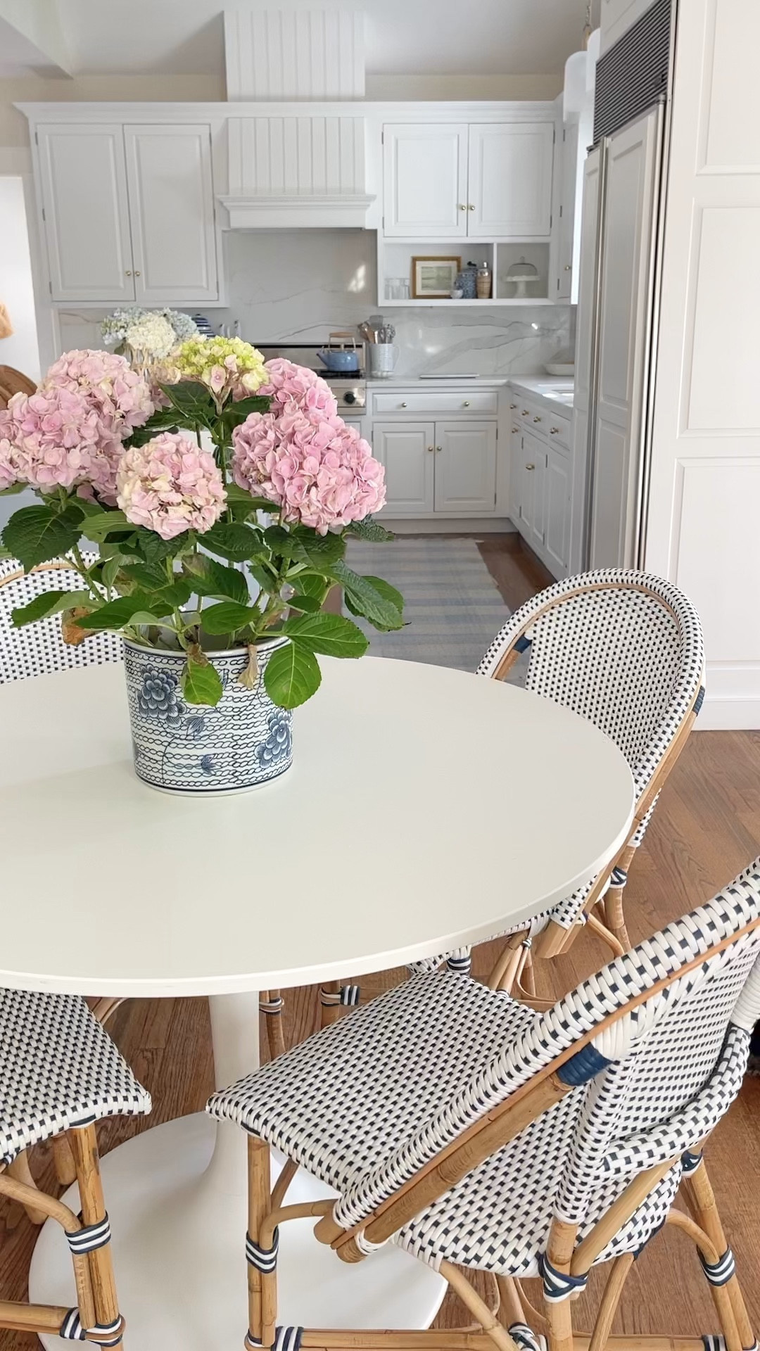 Shop our blue and white coastal kitchen here! We love our bistro kitchen dining chairs so much that we bought the coordinating swivel counter stools! Gingham runner and kitchen accessories linked too!

Kitchen table is IKEA docksta but I linked similar options 🤍
Hydrangea plant is real from Trader Joe’s’!

#LTKhome #LTKFind