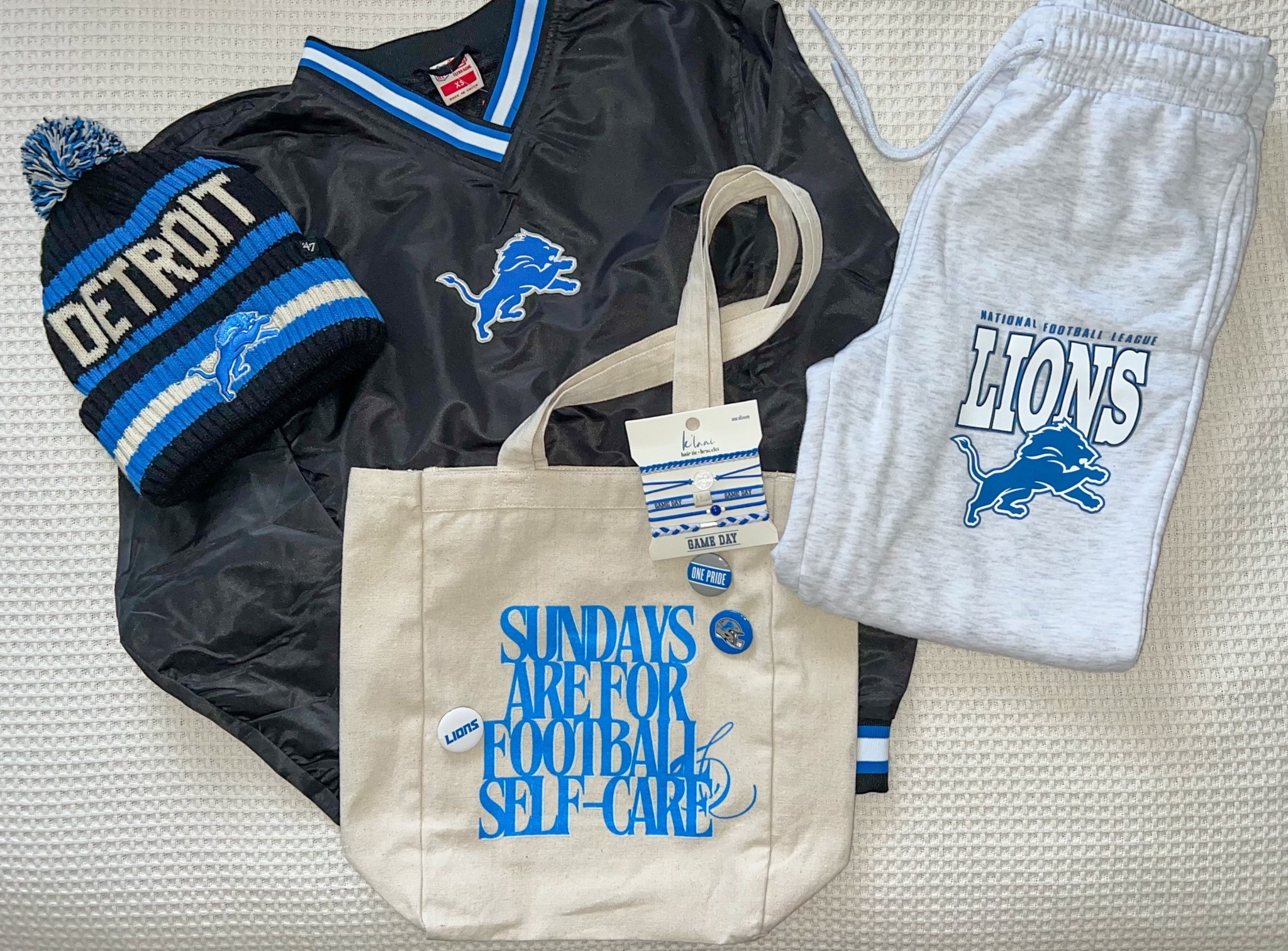 Gettin’ game day ready with some new finds 💙🏈🤍

• Windbreaker Jacket - Aeropostale, XS
• Cuffed Beanie - Rally House, OS
• Sweatpants - Primark, XS
• Tote Bag - MentalWealthSociety, OS
• Lions Buttons - Rally House, 4pk
• K’lani Game Day Hair Ties/Bracelets - local store

#LTKItBag #LTKFindsUnder100 #LTKStyleTip