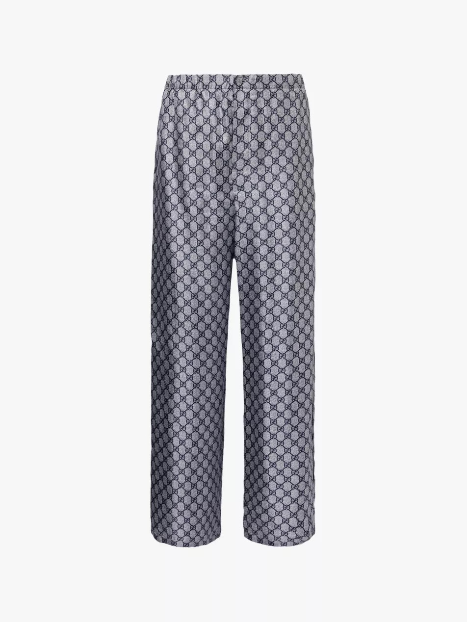 Supreme branded-pattern wide-leg silk trousers | Selfridges