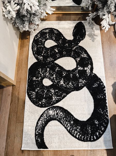 Quite literally the best rug to ever grace my home. Is it Christmas based? No. Do I care? Also no. 

Snake 
Home decor
Living room rug 

#LTKhome #LTKfindsunder100 #LTKstyletip