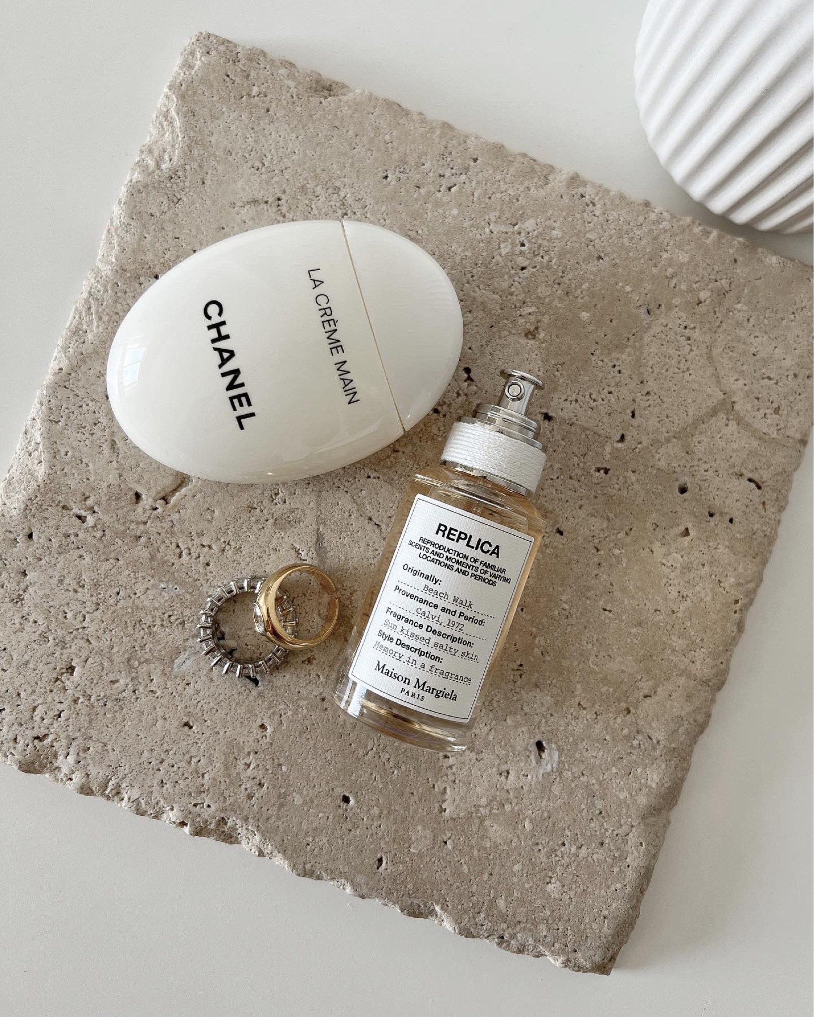 Maison Margiela Replica Beach Walk Eau De Toilette Spray. Summer fragrance perfume. Travertine tile stone tray, Chanel la Creme main hand lotion