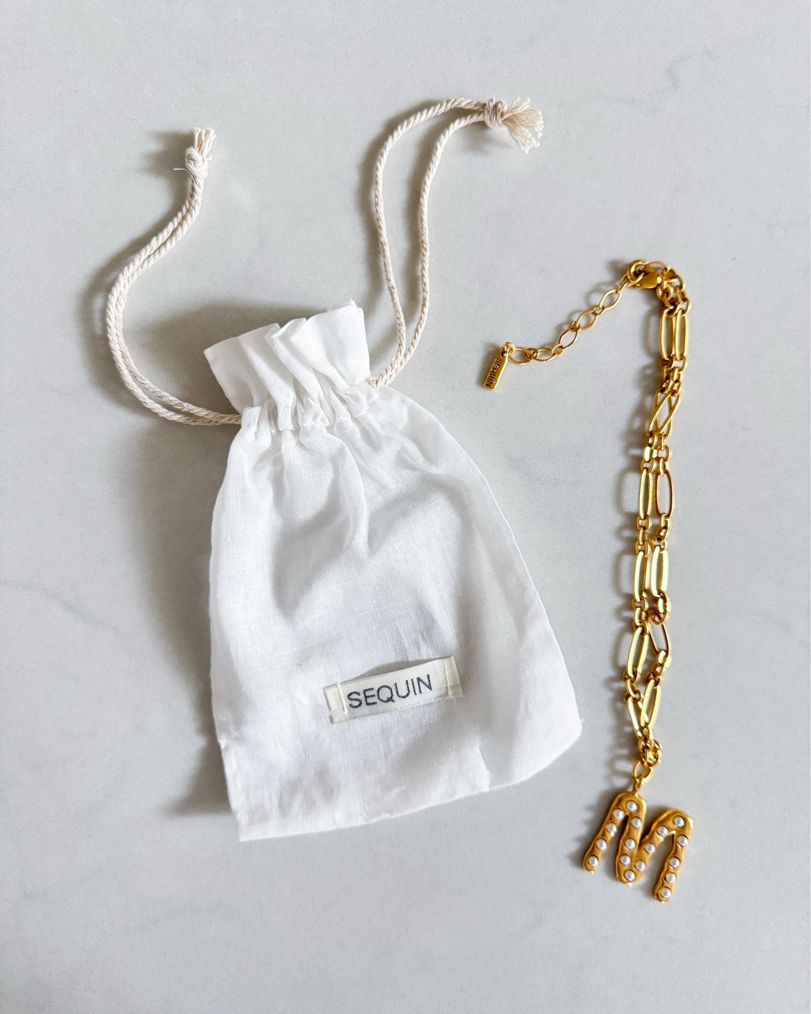 This pearl initial necklace has been my go to lately. It’s bold enough to stand on its own but still classic, which is exactly what I look for in everyday jewelry. The gold chain has a little weight to it, the pearl detailing softens the statement letter, & it instantly pulls a simple tee, knit, or blazer together.

I love that it feels personal without being overdone. Such a good gift idea too, especially for Valentine’s Day, birthdays, or a meaningful mom gift. It’s one of those pieces you’ll actually wear on repeat.

pearl initial necklace
gold statement necklace
personalized jewelry
bubble letter necklace
layered gold chains
everyday jewelry staples
minimal classic style
elevated basics accessories
gift for her idea
valentines day jewelry
mother’s day gift idea
custom initial necklace
trending jewelry 2026

#LTKNYFW #LTKU #LTKValentine