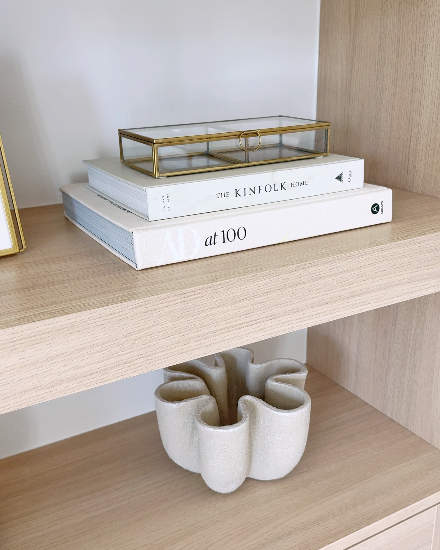 Styling our open shelves with a mix of textures and neutral tones to keep things simple and chic. The layered coffee table books, brass glass box, and sculptural vase add the perfect balance of elegance and interest. Shop similar decor pieces to style your shelves through my LTK.

#LTKHome #LTKFindsUnder50 #LTKStyleTip