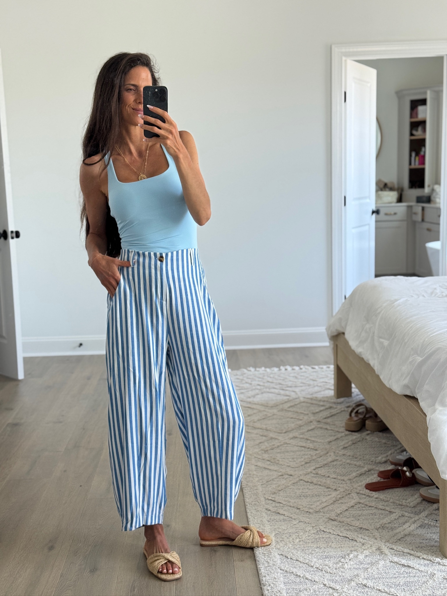 Blue striped pants are having a moment and this easy summer outfit is one I keep reaching for. These breezy wide leg pants, square neck tank, woven sandals, and layered gold jewelry make the perfect casual chic look for vacation, brunch, beach trips, or everyday summer outfits. Everything is comfy, flattering, and easy to mix and match for summer.

#LTKSeasonal #LTKmomlife #LTKootd