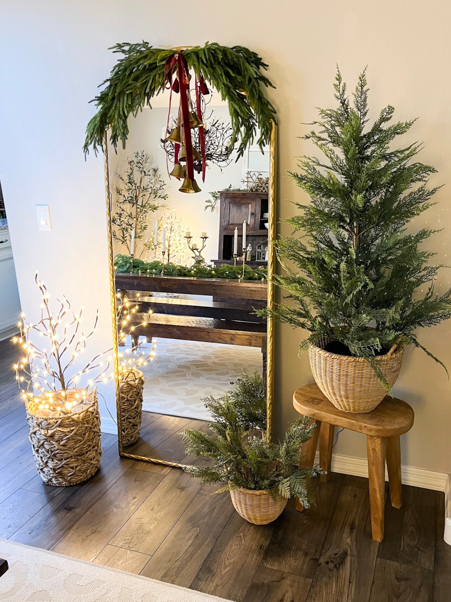 Let’s dress up this mirror!  Follow @lifeinmyarizonahome on Instagram for more holiday ideas and inspiration. 

I added some greenery to the mirror in my dining room using four 36 inch Norfolk stems that I attached together with floral wire.  Velvet ribbon and hanging gold bells help complete the look.  
These beautiful matching baskets in the small and medium size on the right side were perfect for the 4 foot cypress tree, and in the smaller basket I added stems. 
The other side of the mirror has one of three light up branch trees that I have around the dining room.  

#christmasdecor #holidaydecor #christmas #holidayhome 

#LTKHoliday #LTKHome #LTKSeasonal