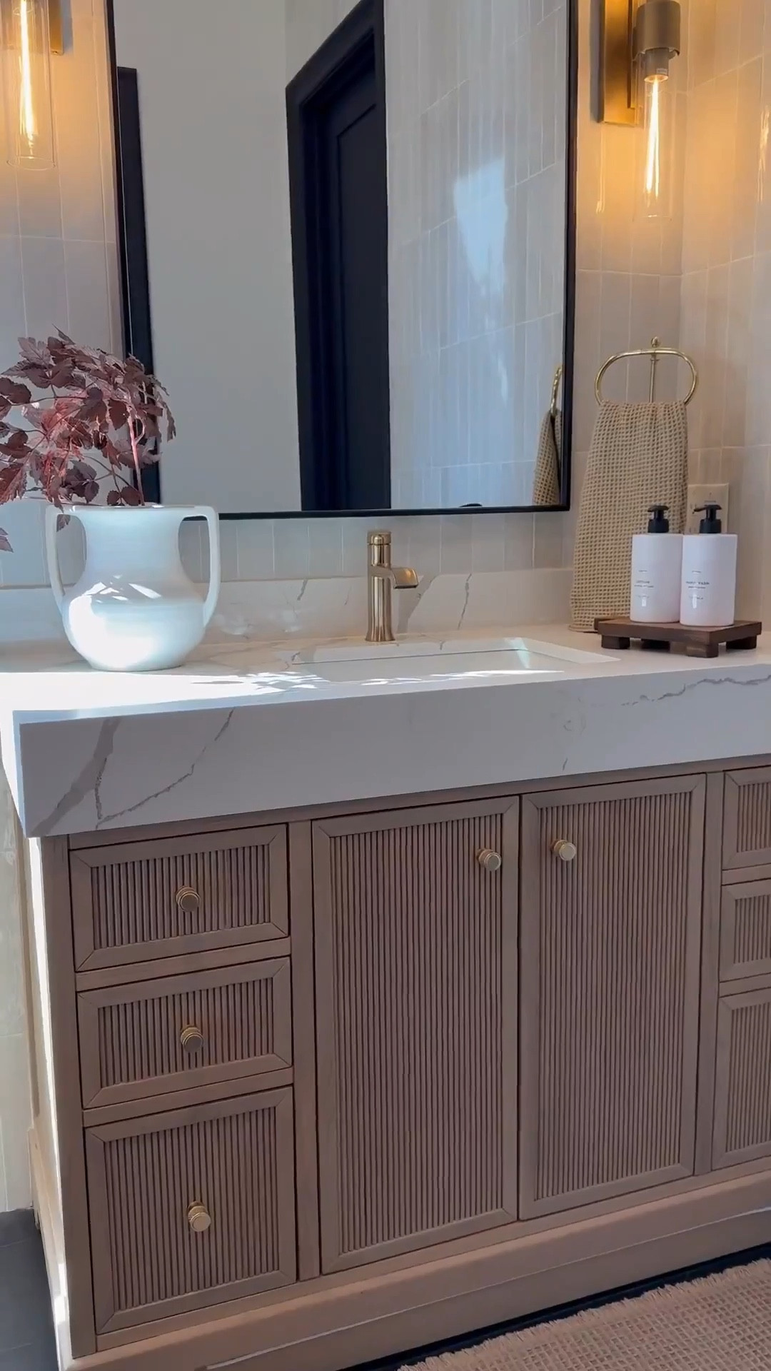 My bathroom vanity feels so warm and inviting with a few seasonal accents like these cimicifuga stems 🌿 The brown accent chair adds the perfect cozy tone 🪑 and I love how the backsplash and vanity combo keep everything neutral while still adding warmth 🤍

My artwork has been such a favorite 🎨 available in so many sizes and styles, it’s perfect 🤩 I’m also obsessed with my white oak console and dining tables that carry that same warmth throughout my home. And this vintage-inspired vase is so versatile, it works beautifully as a planter and adds that timeless look.🏺✨

#LTKHome #LTKSaleAlert