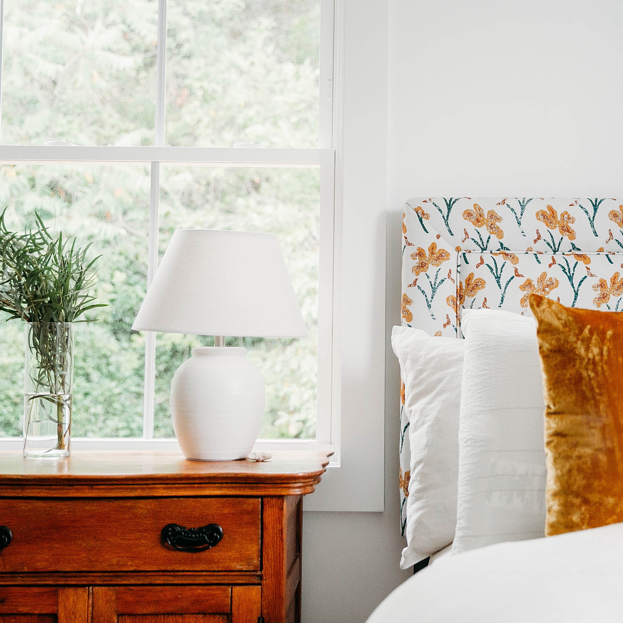 we love to create warm and inviting spaces for guests! we designed this cozy guest room as part of a #dwelloctoberstudio renovation and just love how peaceful and inviting it turned out! a floral patterned fabric headboard and gold velvet throw pillows add color to an otherwise neutral room. a vintage cabinet serves as an end table and also adds warmth and texture to the space. #dwelloctober

#LTKhome