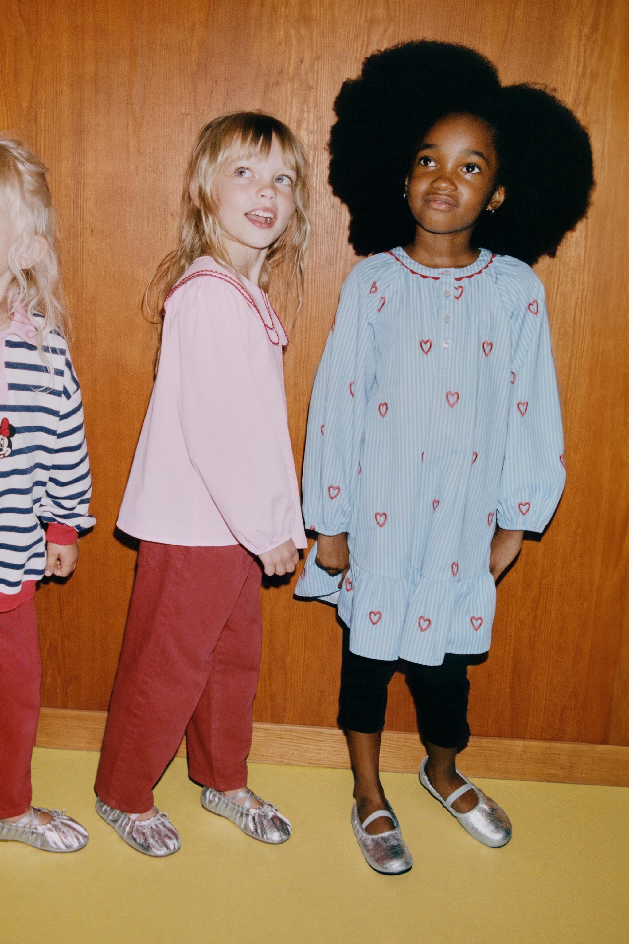 Dress with a round neck and long sleeves with elasticated cuffs. Button fastening on the front yo... | Zara UK