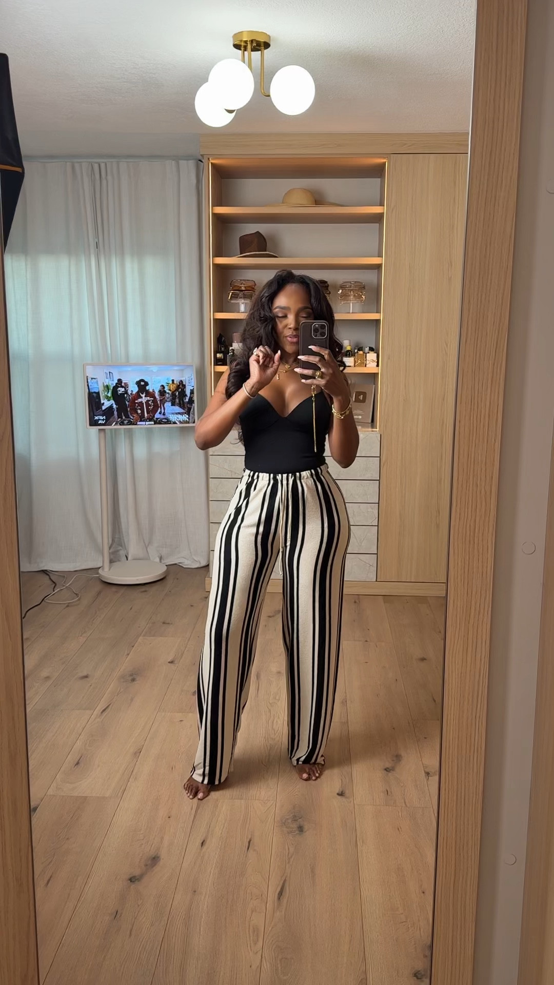 Hi babes!  

These striped pants are EVERYTHING. This is your hero piece — lightweight, elongating, and snatches the waist without clinging. If you’ve been looking for that easy, flattering summer pant… this is it.

I paired it with a simple black bodysuit and gold accessories for that YSL-type look — clean, elevated, and expensive without actually being expensive.

These are a top seller right now and I’m calling it early — high sell-out risk. The vertical stripe + relaxed fit is exactly why these go viral every time.

At this price point, this is a no-brainer. This is that throw-on-and-look-put-together outfit you’ll wear on repeat, so the cost per wear drops fast.

Where to wear:
• Brunch  
• Vacation  
• Casual dinners  
• Everyday errands but elevated  

Everything is linked below ✨  

📏 Measurements: 5’4”, 140 lbs, 34D bust, 27” waist, 40” hips  

Follow me on Instagram and YouTube @kirasfashionfinds  