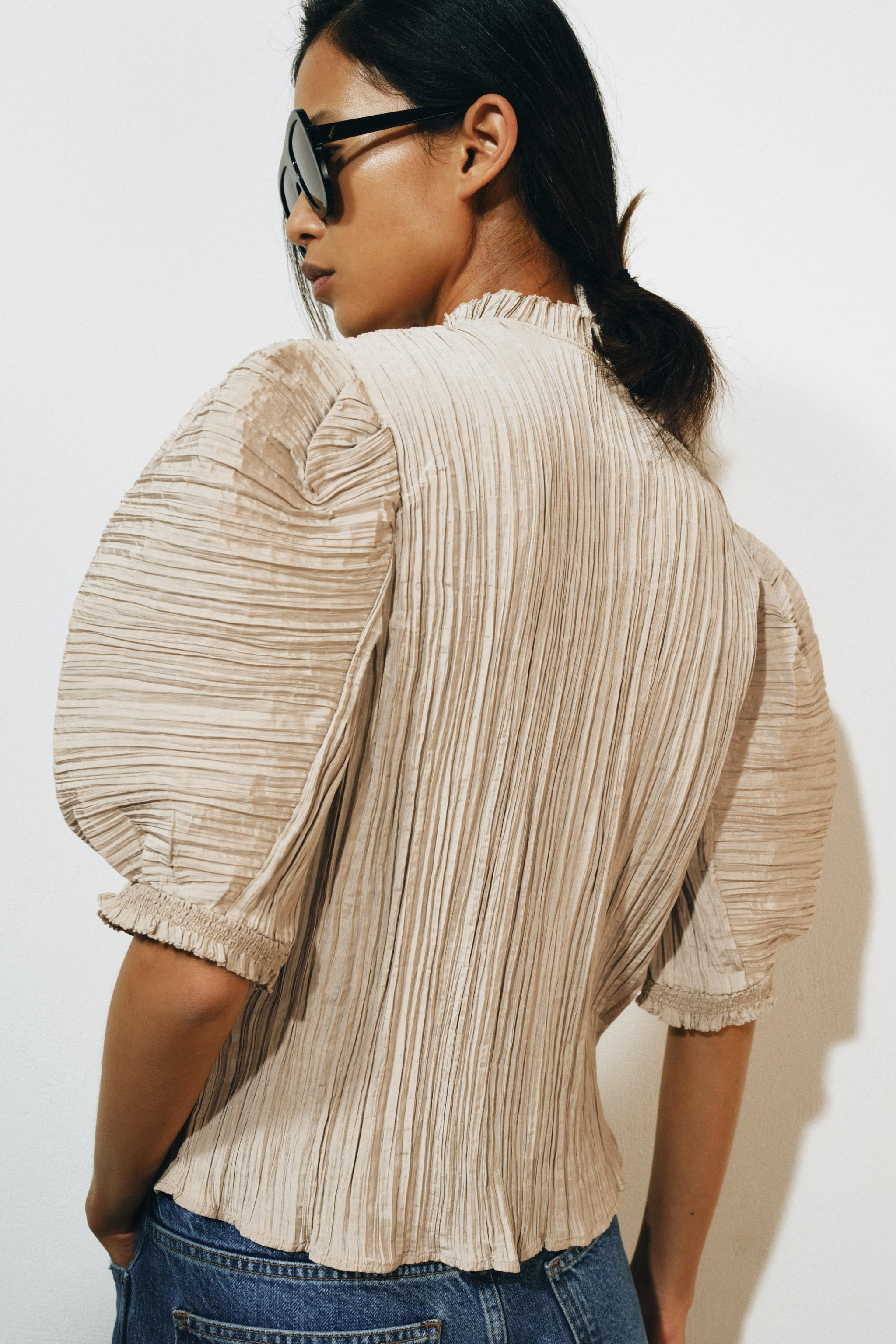 ZARA WOMAN COLLECTIONShirt with a round neck and short puff sleeves. Pleated fabric detail. Strai... | Zara US