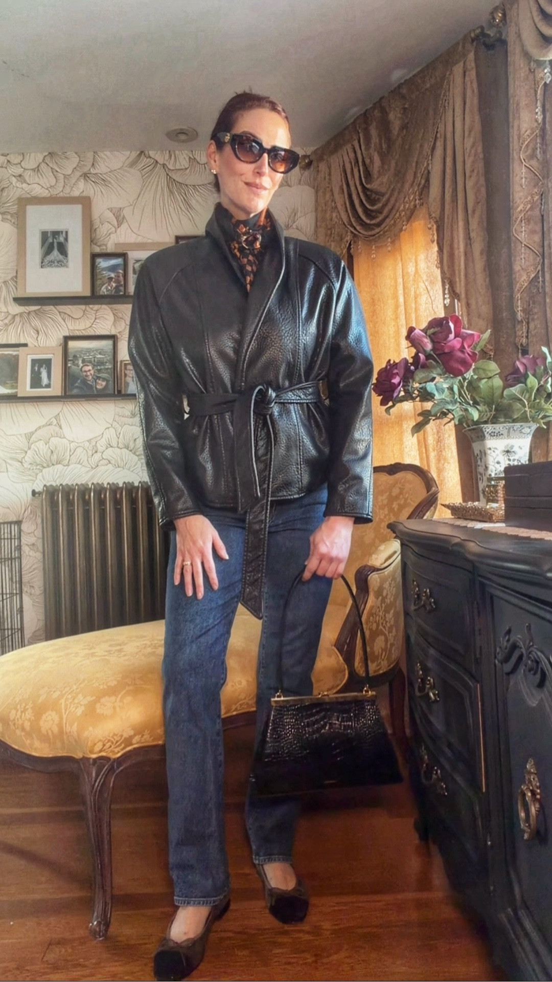 Classic with a little edge. This look mixes a sculptural belted leather jacket with straight-leg denim, a printed neck scarf, oversized sunglasses, and a polished top-handle bag for that effortless vintage-meets-modern feel. A great example of how a strong jacket can do all the heavy lifting while timeless accessories keep the outfit elevated and chic. #LTKStyle #LTKFinds #LTKSeasonal #LeatherJacket #StraightLegJeans #ClassicStyle #VintageInspired #ElevatedBasics #EverydayStyle #ChicOutfit #PersonalStyle #SpringStyle