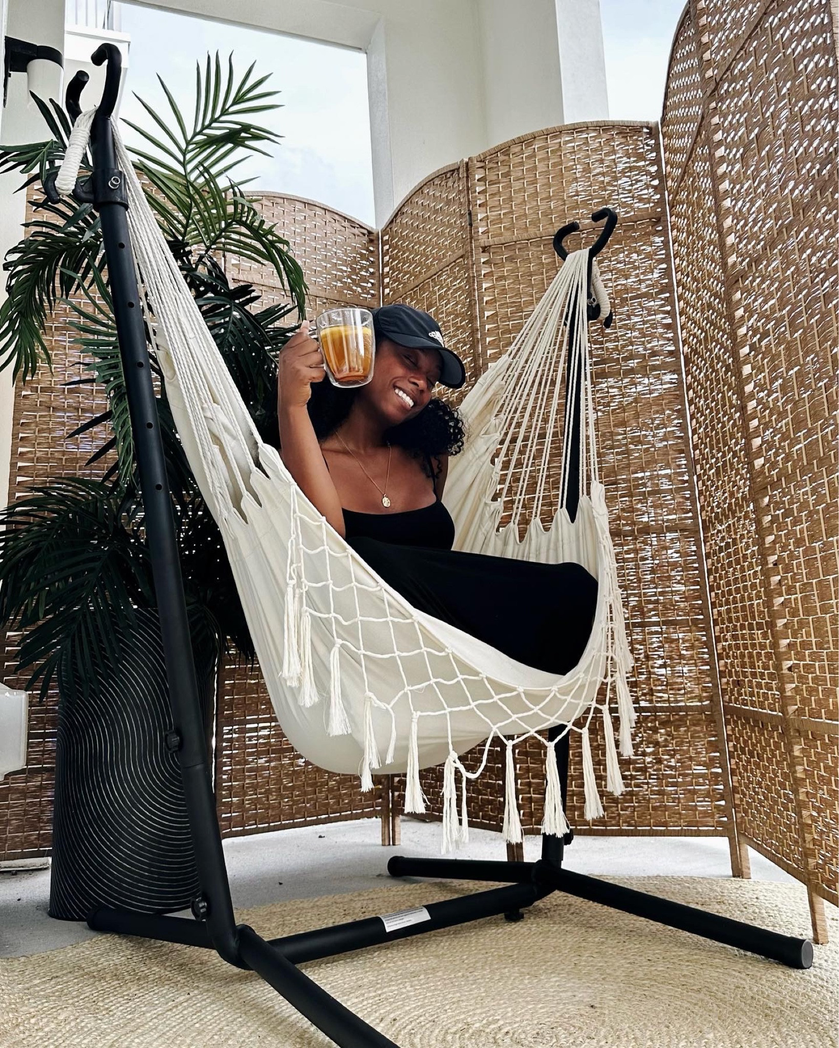 Swinging boho hammock chair for apartment balcony with faux palm tree plant and rattan room divider for cozy boho chic balcony decor 

#LTKhome #LTKSeasonal