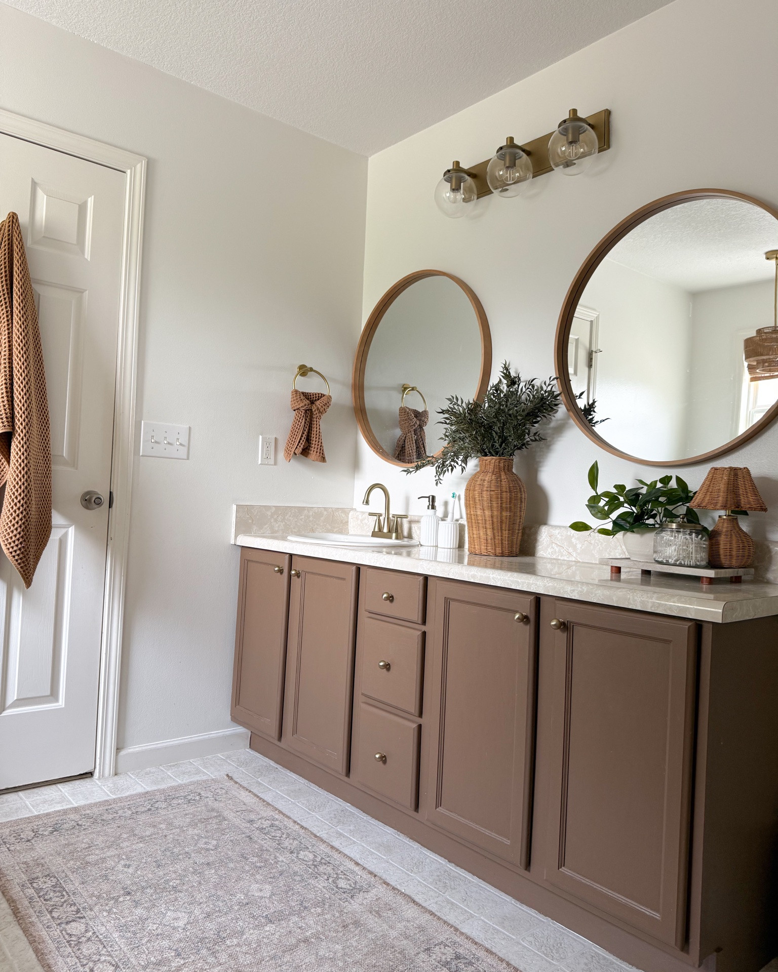 Bathroom countertop styling ideas. Mini wicker lamp back in stock. Tray styling idea. Glass canisters with gold lid.

#LTKHome #LTKSaleAlert #LTKSeasonal