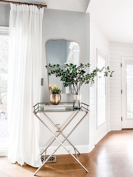 Love this Studio McGee wall mirror and artificial green branch stems from Amazon.

Dining room decor, beverage stand, mirrored top table, x leg side table, Amazon drapes, pinch pleat drapes, faux linen curtains, gold curtain rod, curtain clip rings, beverage refrigerator, wine refrigerator, home decor coffee table design book, arched wall mirror.

#LTKstyletip #LTKFind #LTKhome