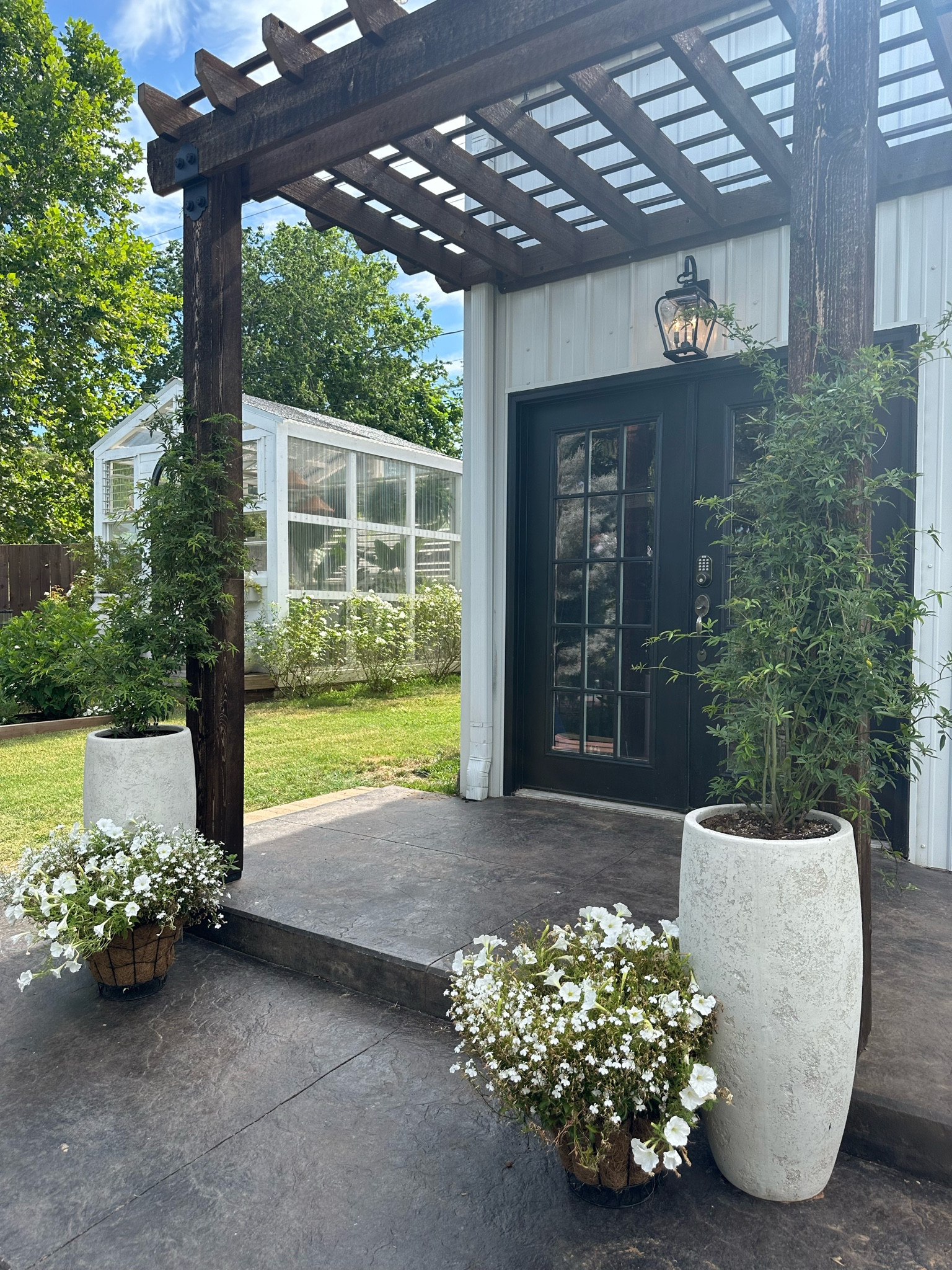 Outdoor lighting. Organic modern planter vibes. Earthy neutral backyard. Greenhouse. Metal shop building  

#LTKhome #LTKSeasonal