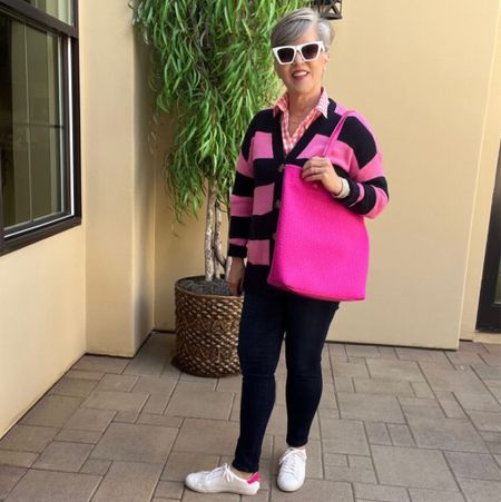 #ltkfind
#ltkbag
Spring casual look with a navy cardigan (S)/ over a pink and white gingham shirt (M)/ over Wit and Wisdom skinny jeans (6)/pink edged sneakers (8)/and a pink tote

#LTKshoecrush #LTKunder50 #LTKSeasonal