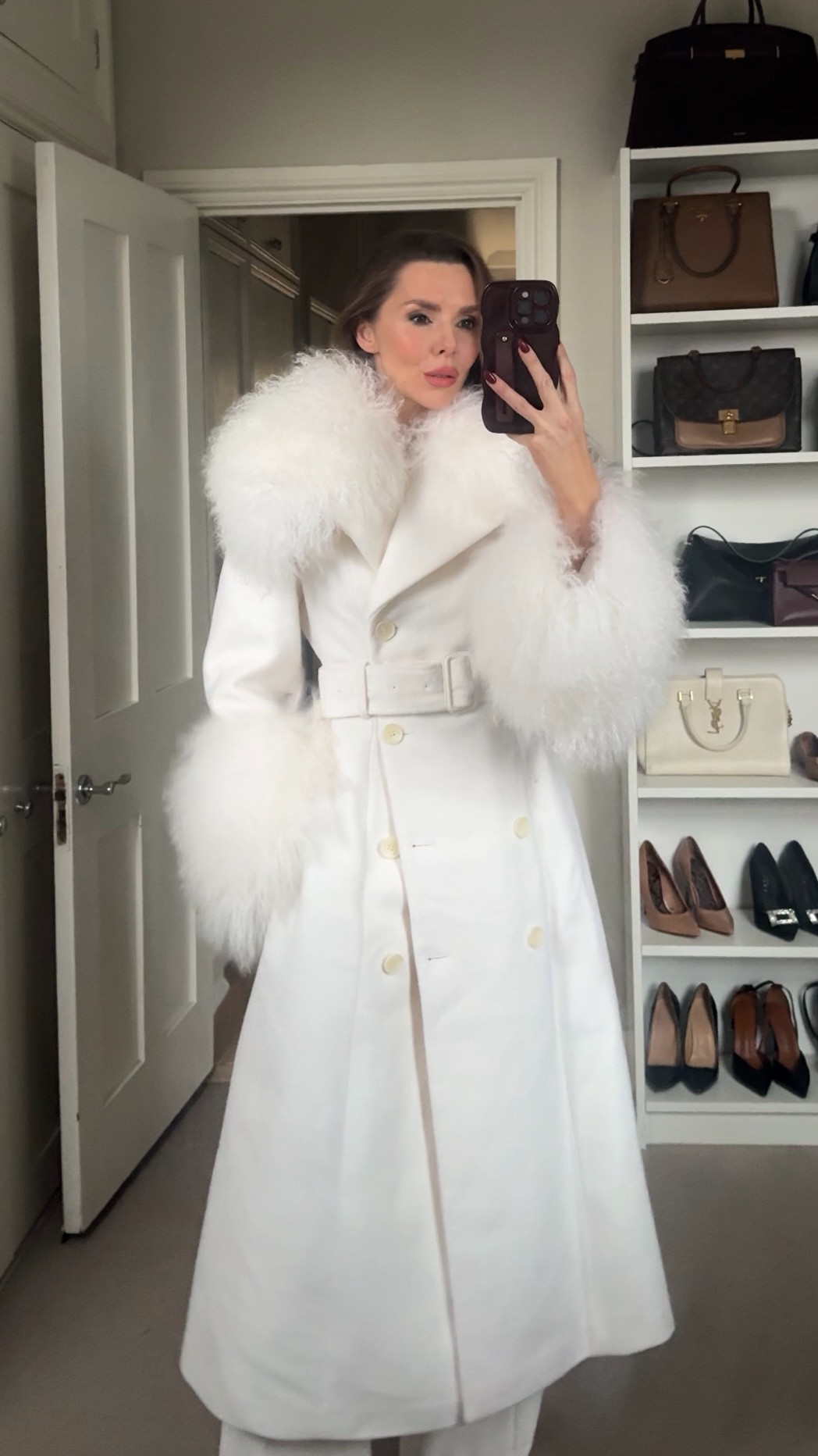 
An ivory long belted coat with a soft Mongolian-style fur collar and matching fur cuffs. Elegant, dramatic, and the kind of coat that does all the talking.

#LTKuk #LTKluxury #LTKwinter