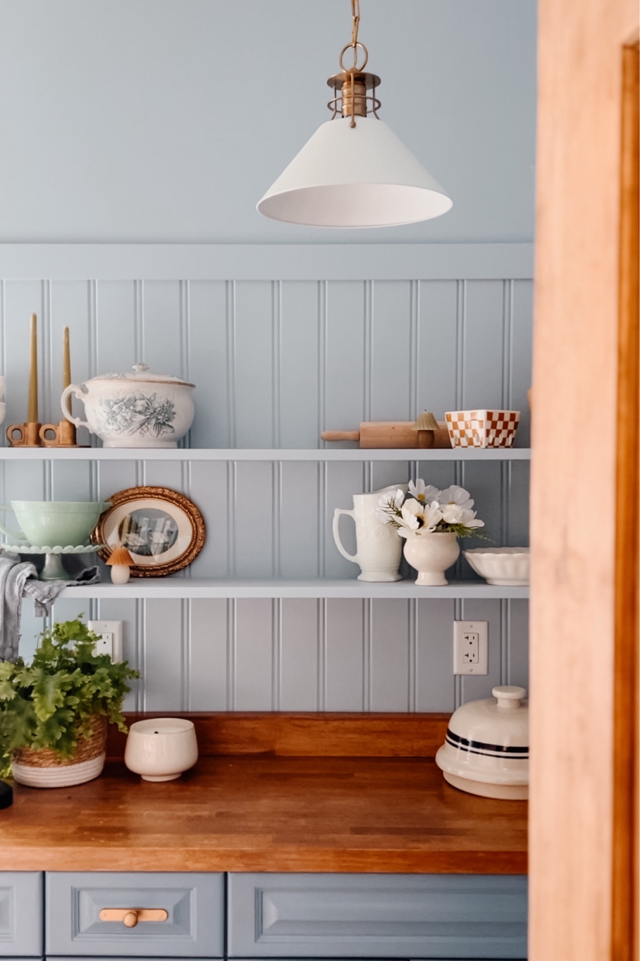 Pantry wide wainscotting, pine wooden interior door, pendant light, butcher block counter top 

#LTKhome