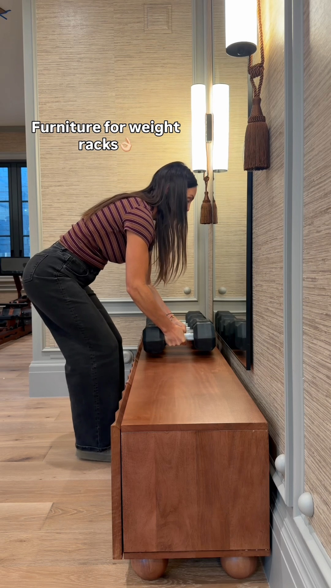 DIY luxe home gym- feels like a spa. 
Squat rack
Grasscloth wallpaper
Console table for weight racks
Stone sconces with tassels 
Wall molding and bobbin detail.