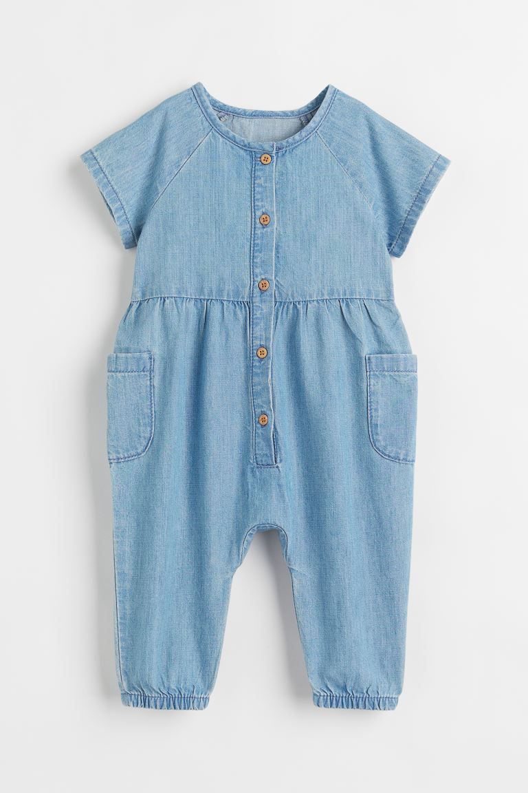 Jumpsuit in washed cotton denim. Buttons at front, short raglan sleeves, and open leg pockets. Na... | H&M (US + CA)