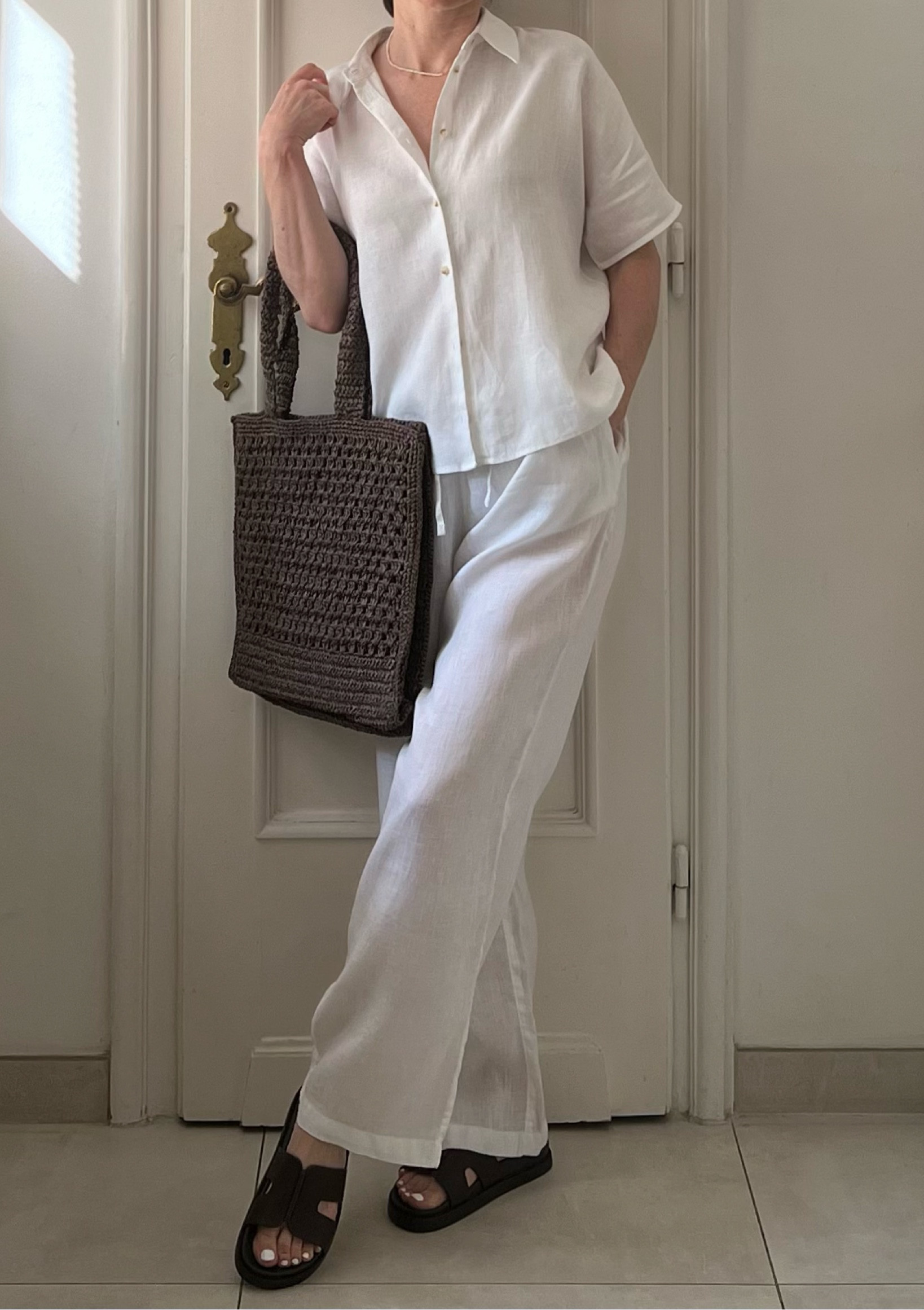 White line outfit, summer outfit, beach outfit, holiday outfit, white trousers, white shirt, white linen trousers, linen drawstring trousers, leather slides, dark brown shoes, shopper bag, brown bag, Mango

#LTKshoes #LTKbag #LTKsummer