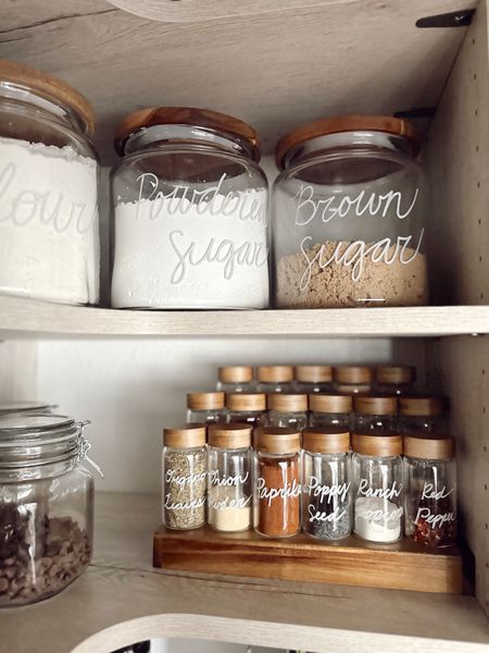 Pantry organization items from The Container Store!  Marie Kondo glass spice jars with wood top.  Glass canisters with wood top.  acacia wood expandable shelf for cans and spices.  Pantry storage - home organization - good storage 

#LTKsalealert #LTKhome #LTKFind