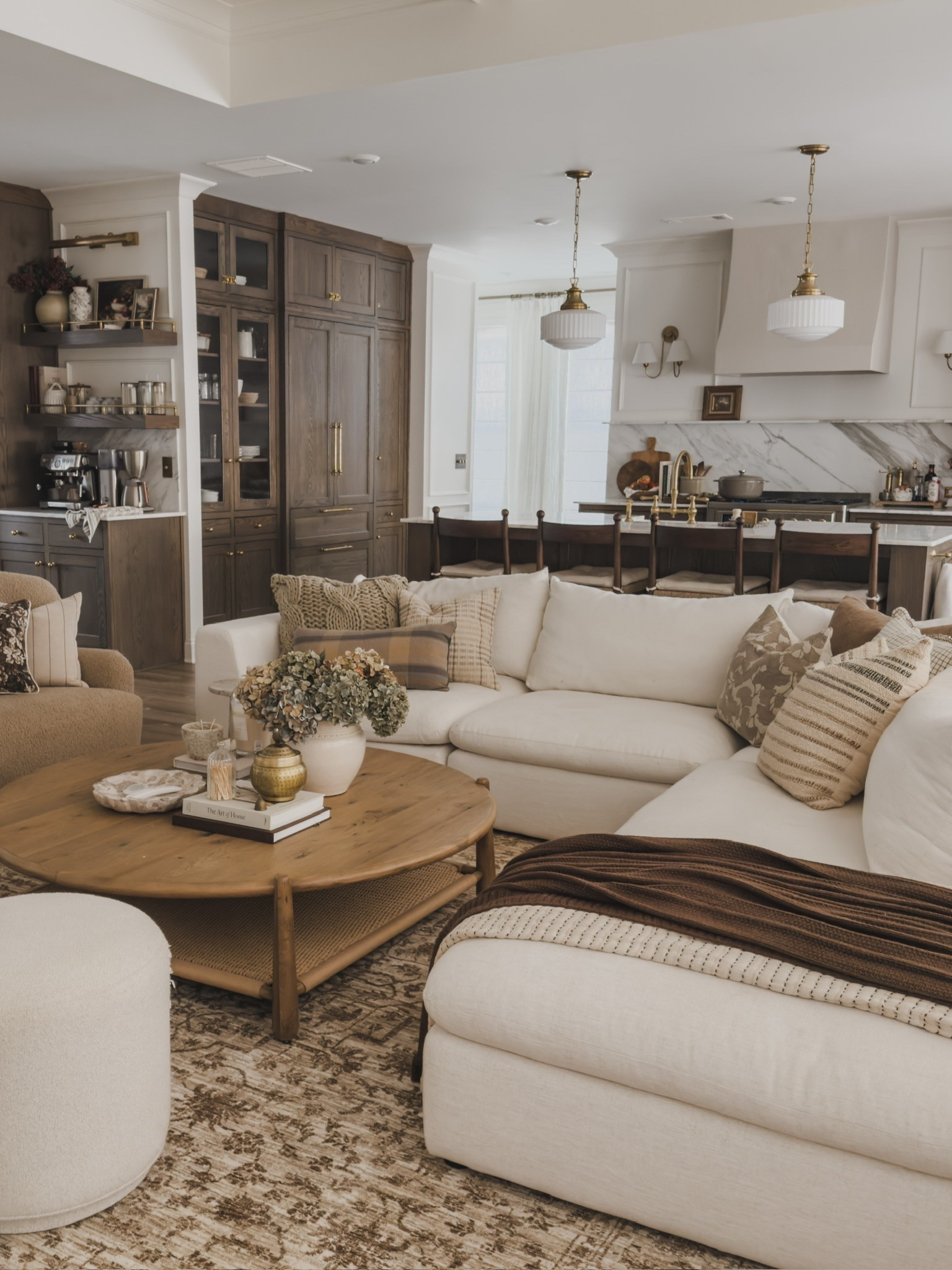 A closer view of my fall living room refresh! So obsessed with all of the warm and cozy vibes. The fall season is all about layers and added textures for a collected style.

Home finds, neutral home inspo, living room refresh, fall refresh, collected style, cozy seating, linen upholstered sectional, oversized coffee table, vintage inspired area rug, ottoman details, cozy throw pillow, kitchen views, coffee table decor, swivel accent chairs, brass detail, faux hydrangeas, cozy throw blanket, Castlery, Pottery Barn style, Four Hands, Wayfair, Lumens, Loloi, found it on Amazon, Home and Kids Co, shop the look!

#LTKSeasonal #LTKHome
