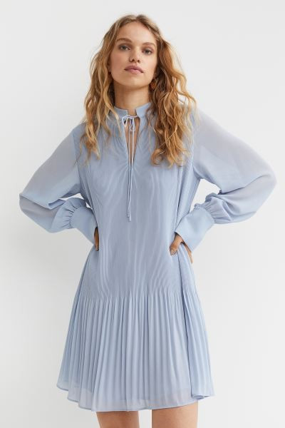 Short, A-line dress in pleated chiffon. Stand-up collar, V-shaped opening at front with narrow ti... | H&M (US + CA)