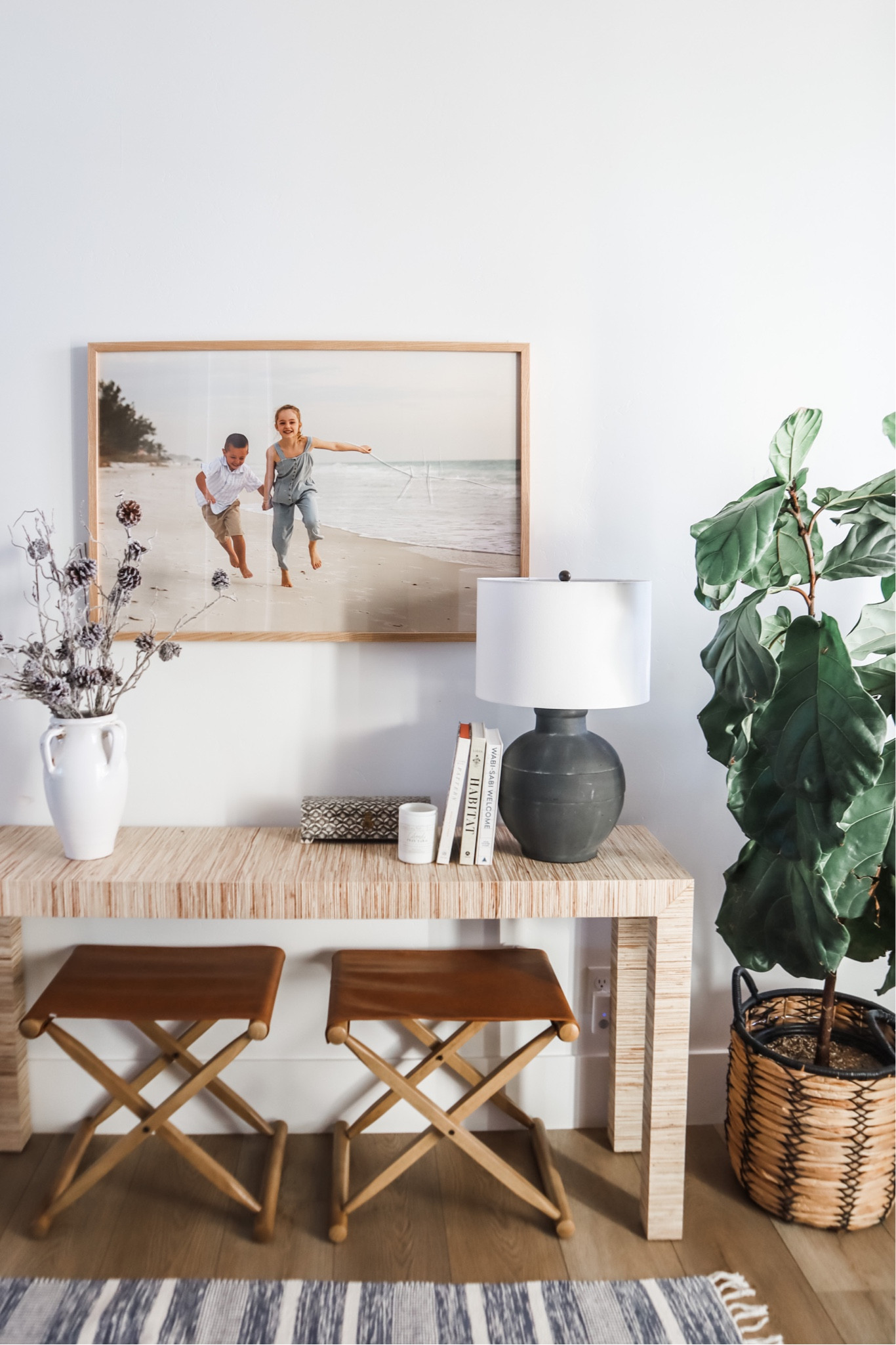 After a solid 3 years of  yearning for the leather camp stools from a certain beachy furniture retailer, I have come to terms with the fact that I will never be ok with paying $600 apiece for a small folding stool.

Like the good cyber sleuth I am, I finally tracked down the perfect “look for less”. And they’re giving me 100 percent of the look I was at 16% of the price.

#leatherstool #consoleyable #entry #entrydecor #designbooks #blacklamp #whitevase #potterybarn #target #grasscloth
#beachhouse

#LTKhome