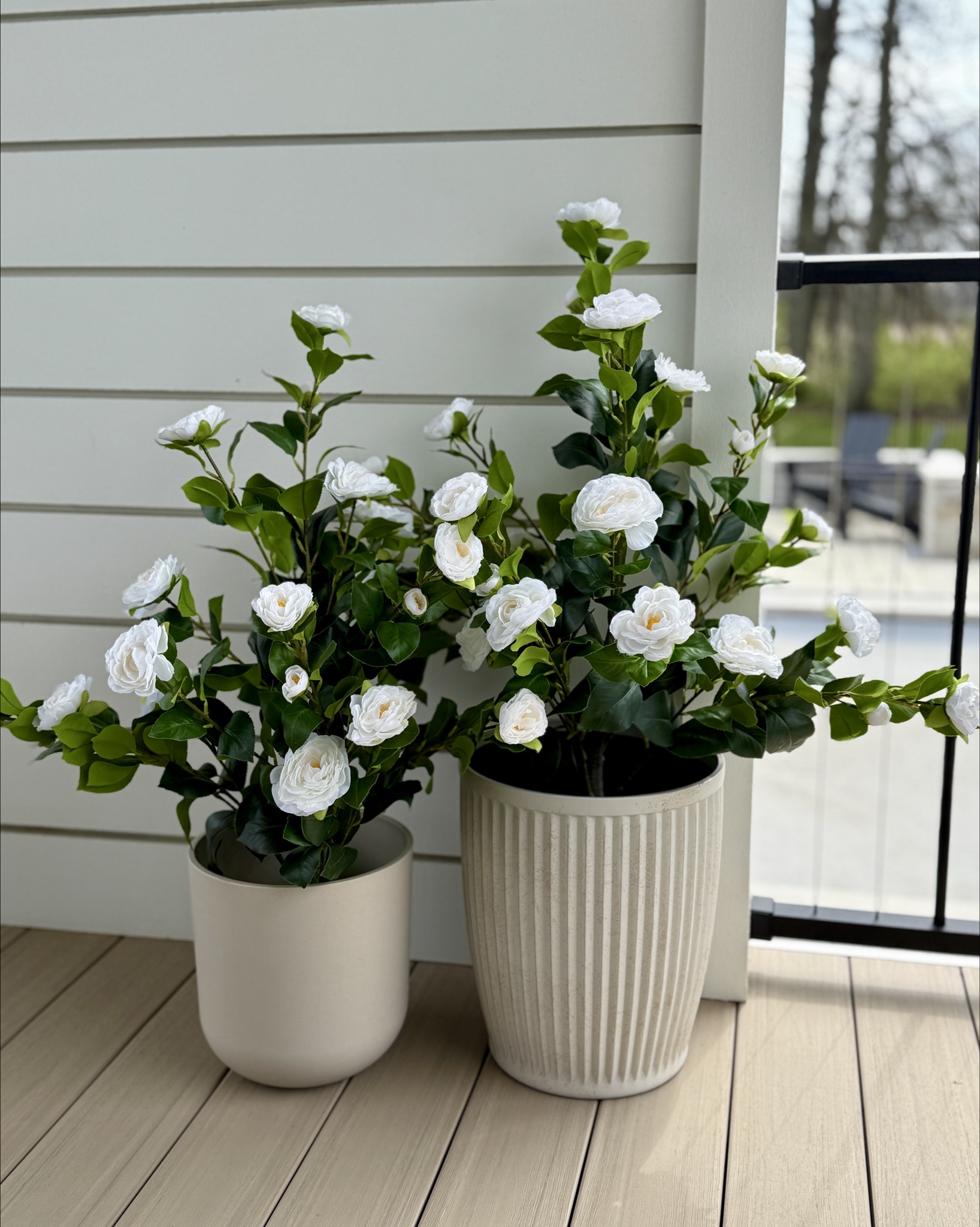 Spring flowers for the back porch! loving these faux camilla bushes 🤍 

patio decor, faux flowers, planters 

#LTKFindsUnder100 #LTKHome #LTKSeasonal