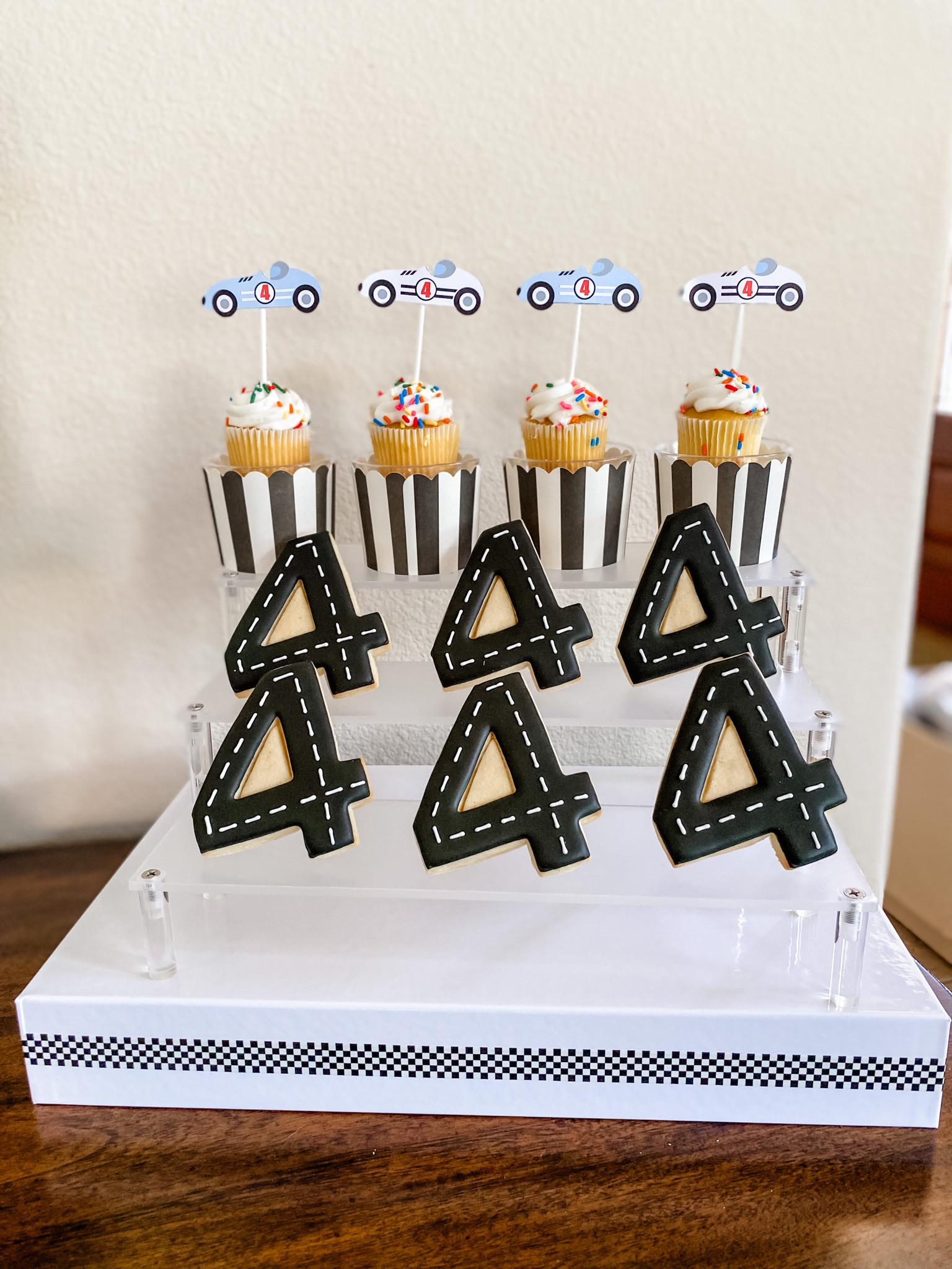 Race car kids party decor. For the box under the risers, I simply took the bottoms from two gift boxes and used checkered tape to hold them together. 

Kids party, race car party, boy party, dessert display, party decor

#LTKkids #LTKparties #LTKfamily