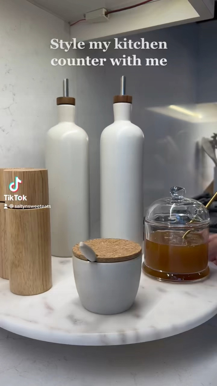 Kitchen counter styling with these beautiful organic modern items - olive oil and vinegar cruet, honey pot, salt and pepper, and small dish on a marble lazy Susan  

#LTKFind #LTKSeasonal #LTKhome